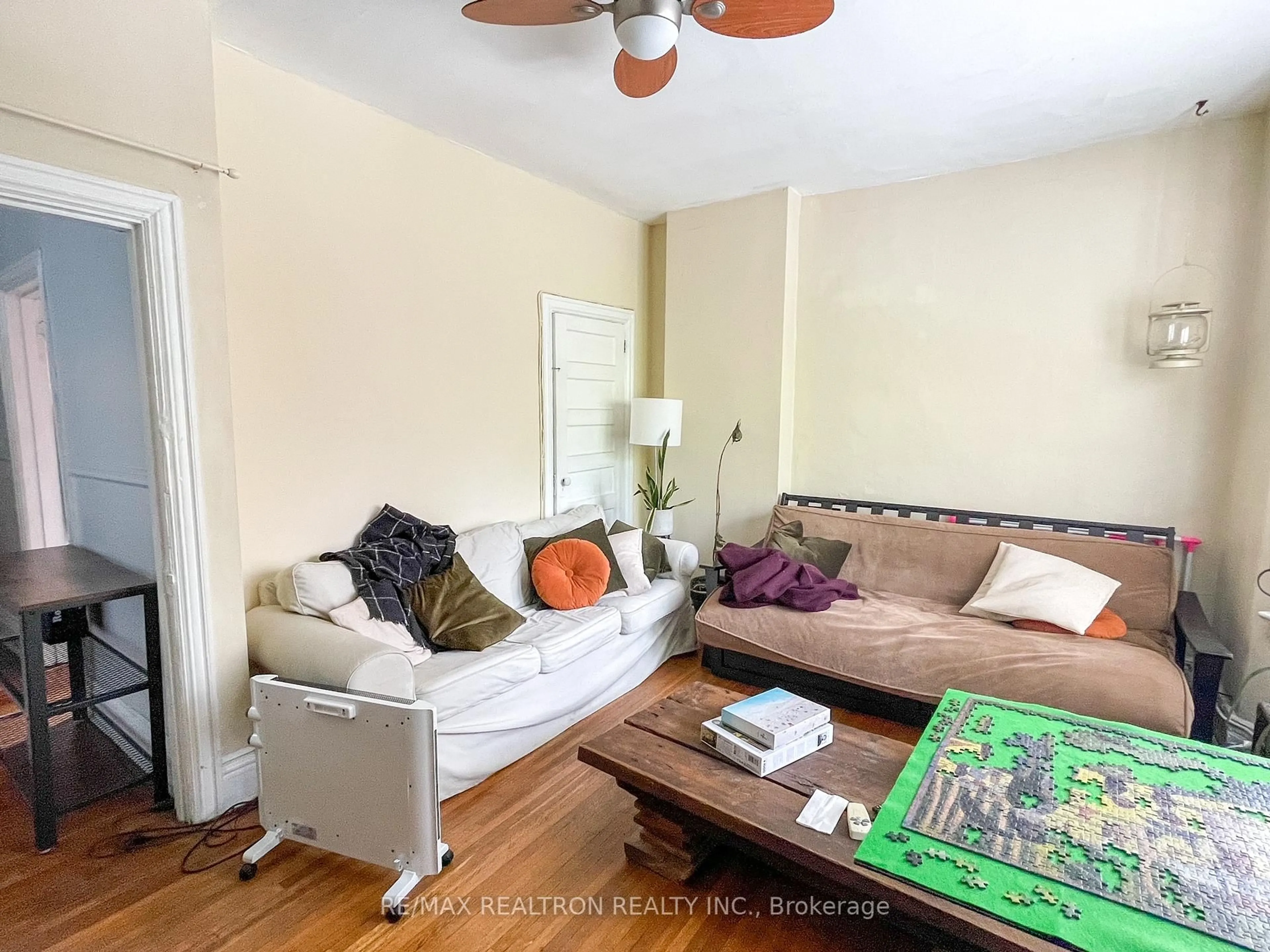 Living room with furniture, wood/laminate floor for 82A Augusta Ave, Toronto Ontario M5T 2L1