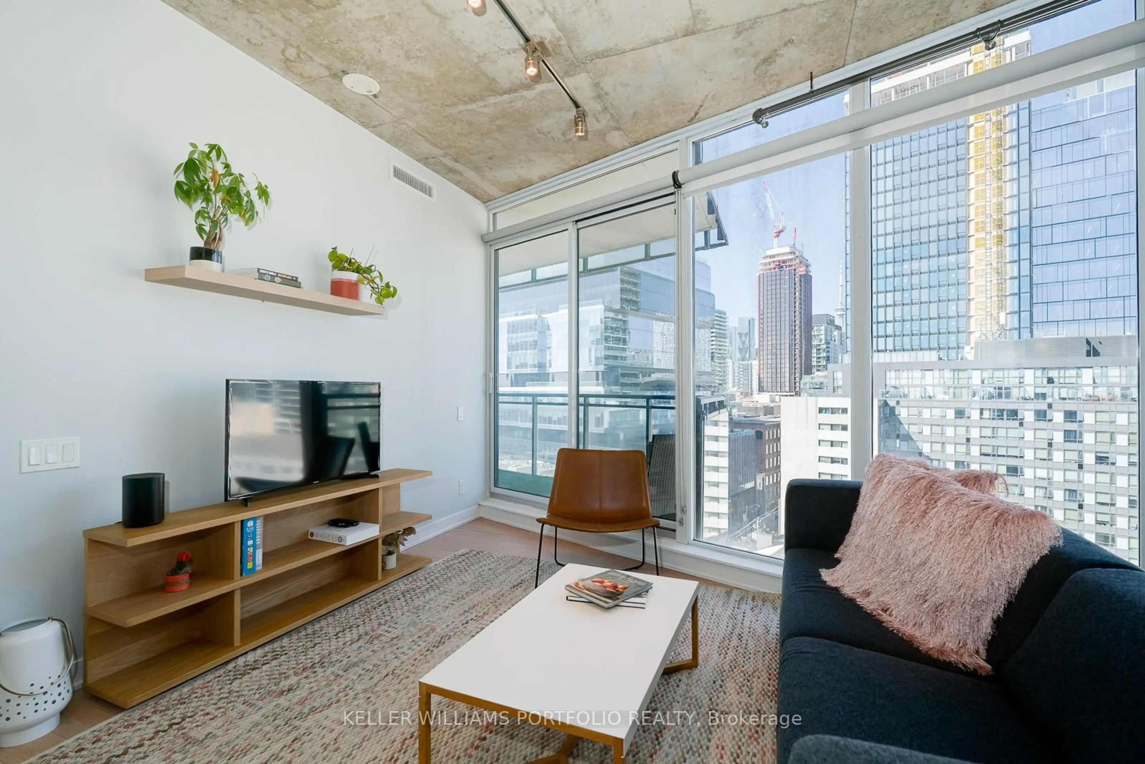 Living room with furniture, cement floor for 318 King St #1212, Toronto Ontario M5A 0C1