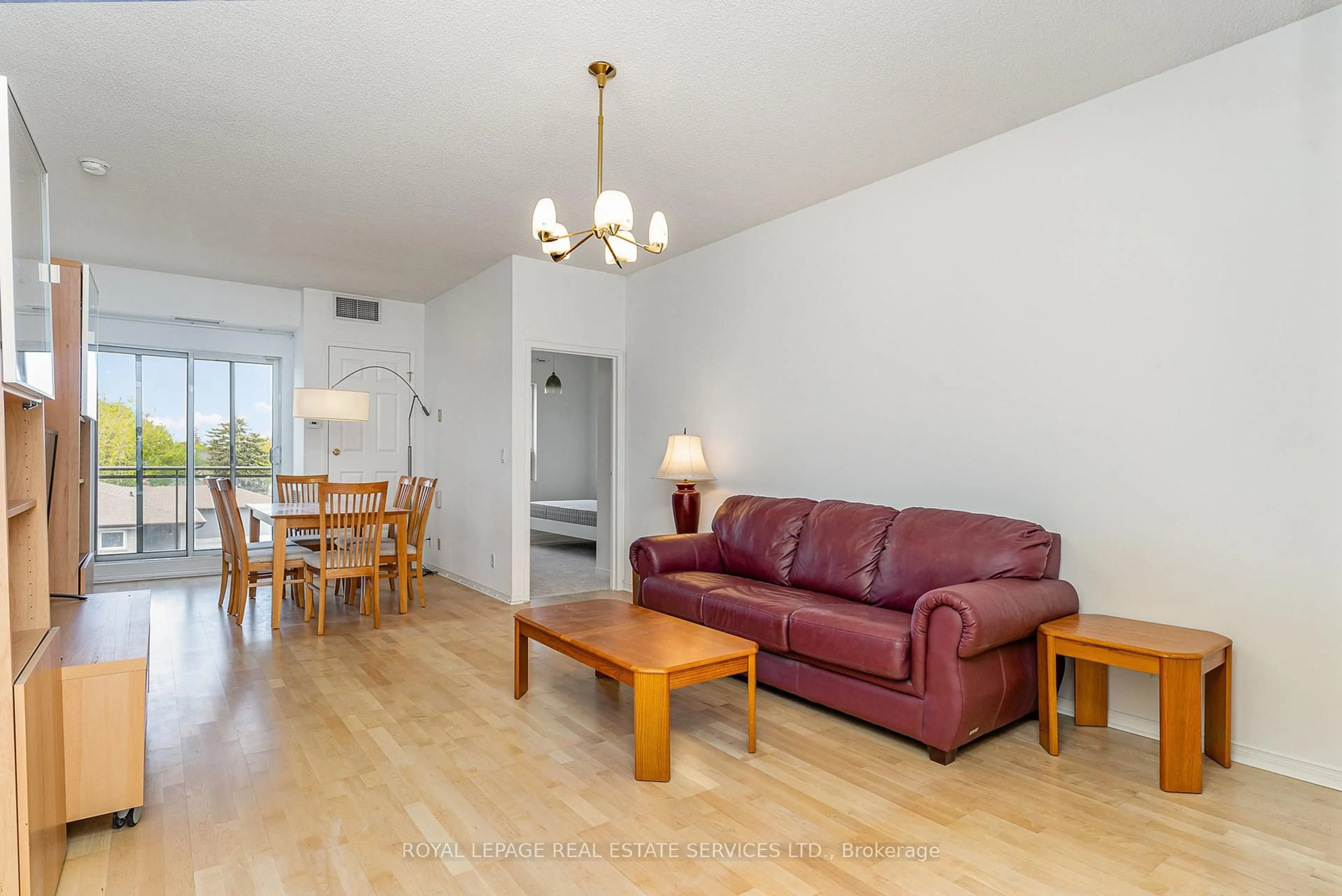 Living room with furniture, wood/laminate floor for 778 Sheppard Ave #303, Toronto Ontario M3H 6B7