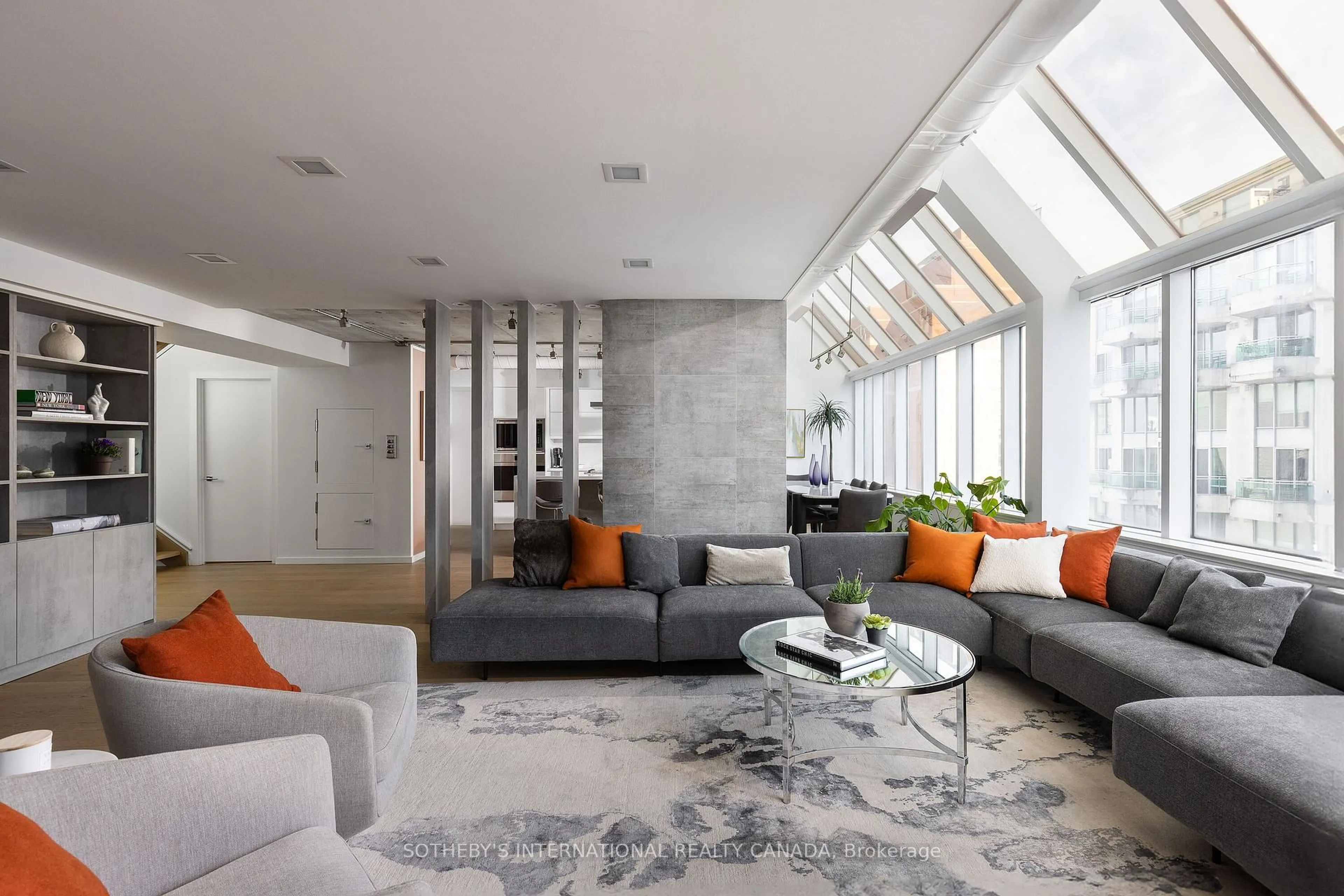 Living room with furniture, cement floor for 82 Lombard St #PH 912, Toronto Ontario M5C 2S8