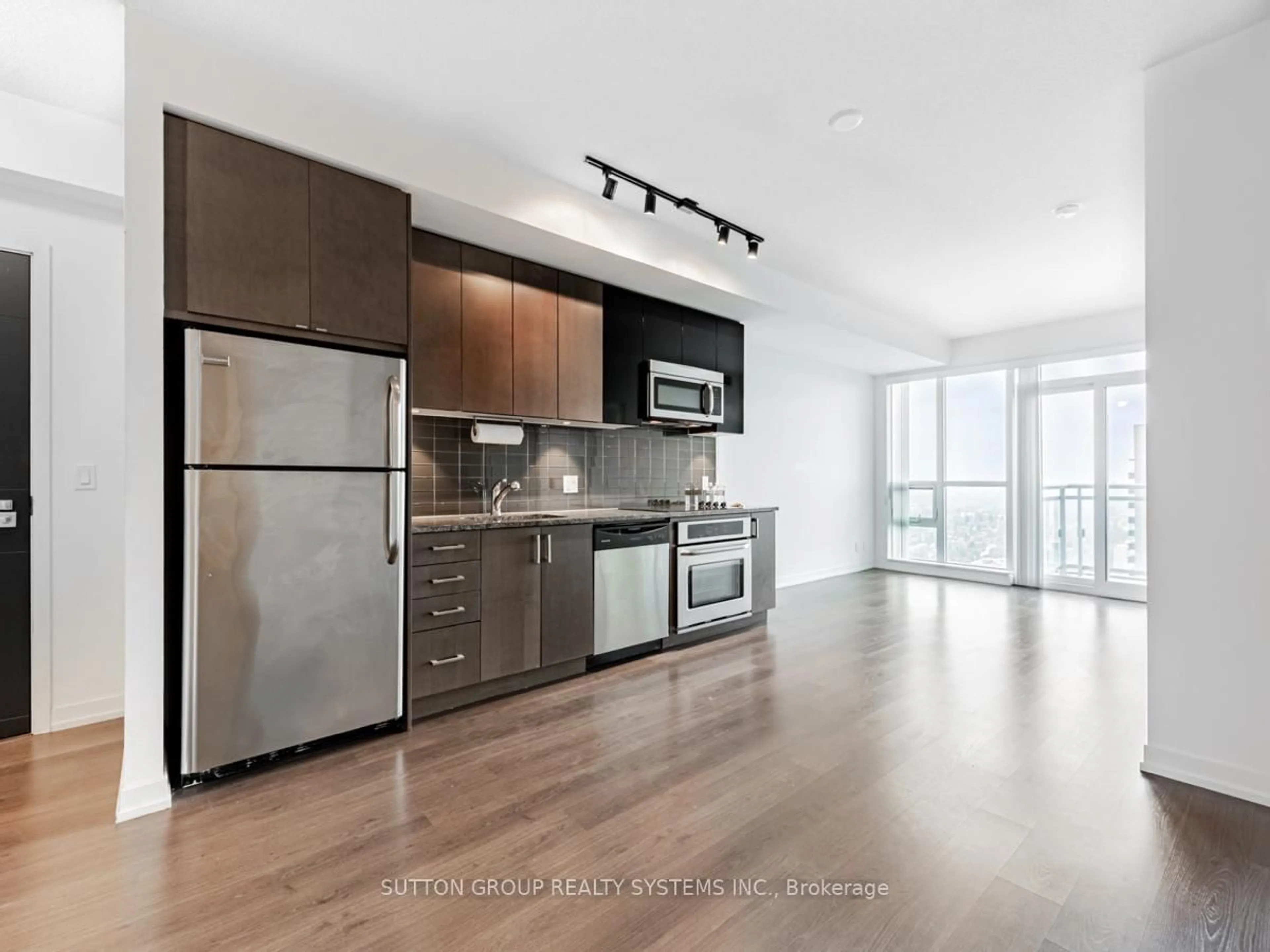 Open concept kitchen, wood/laminate floor for 98 Lillian St #3016, Toronto Ontario M4S 0A5