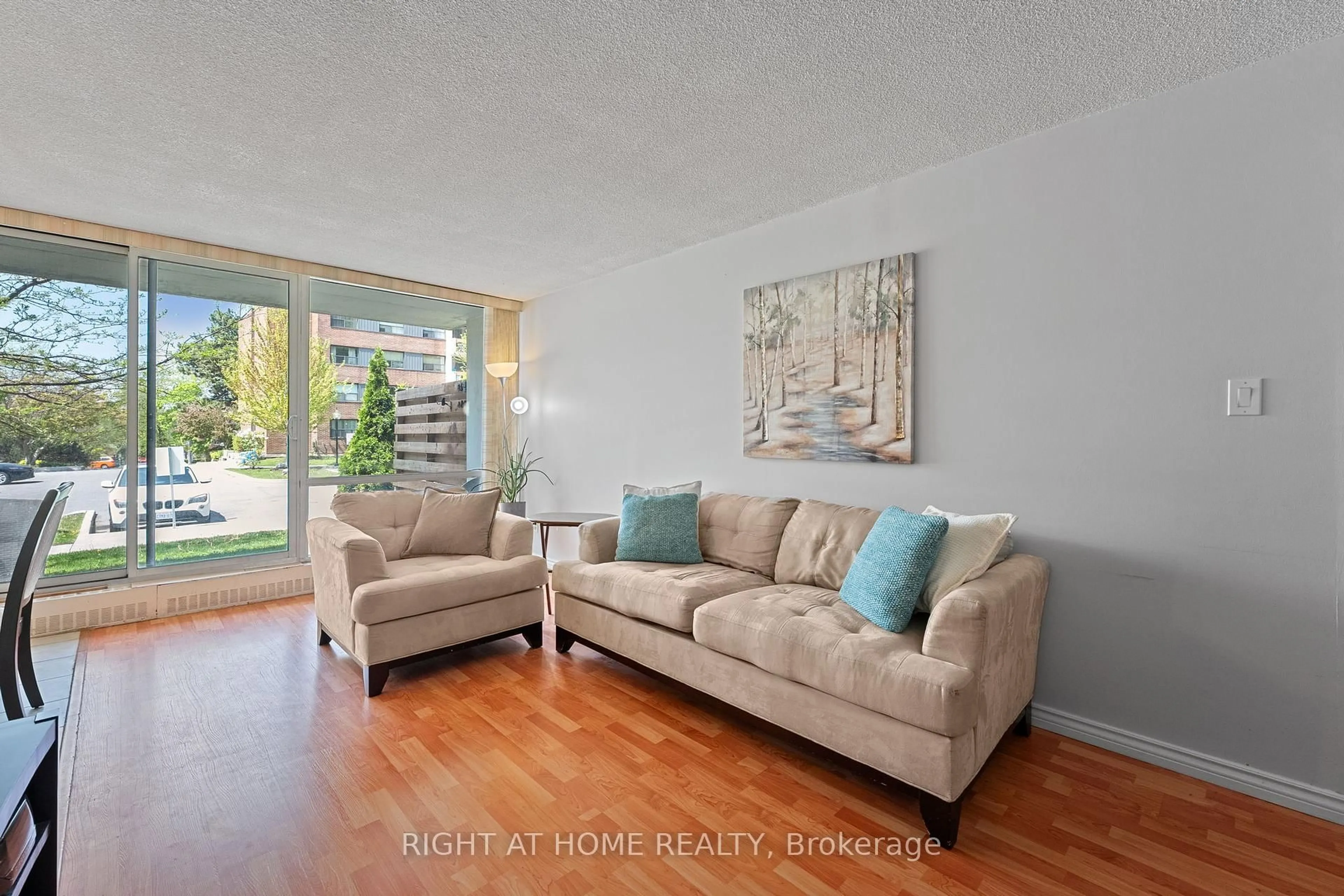 Living room with furniture, wood/laminate floor for 1801 O'connor Dr #102, Toronto Ontario M4A 2P8