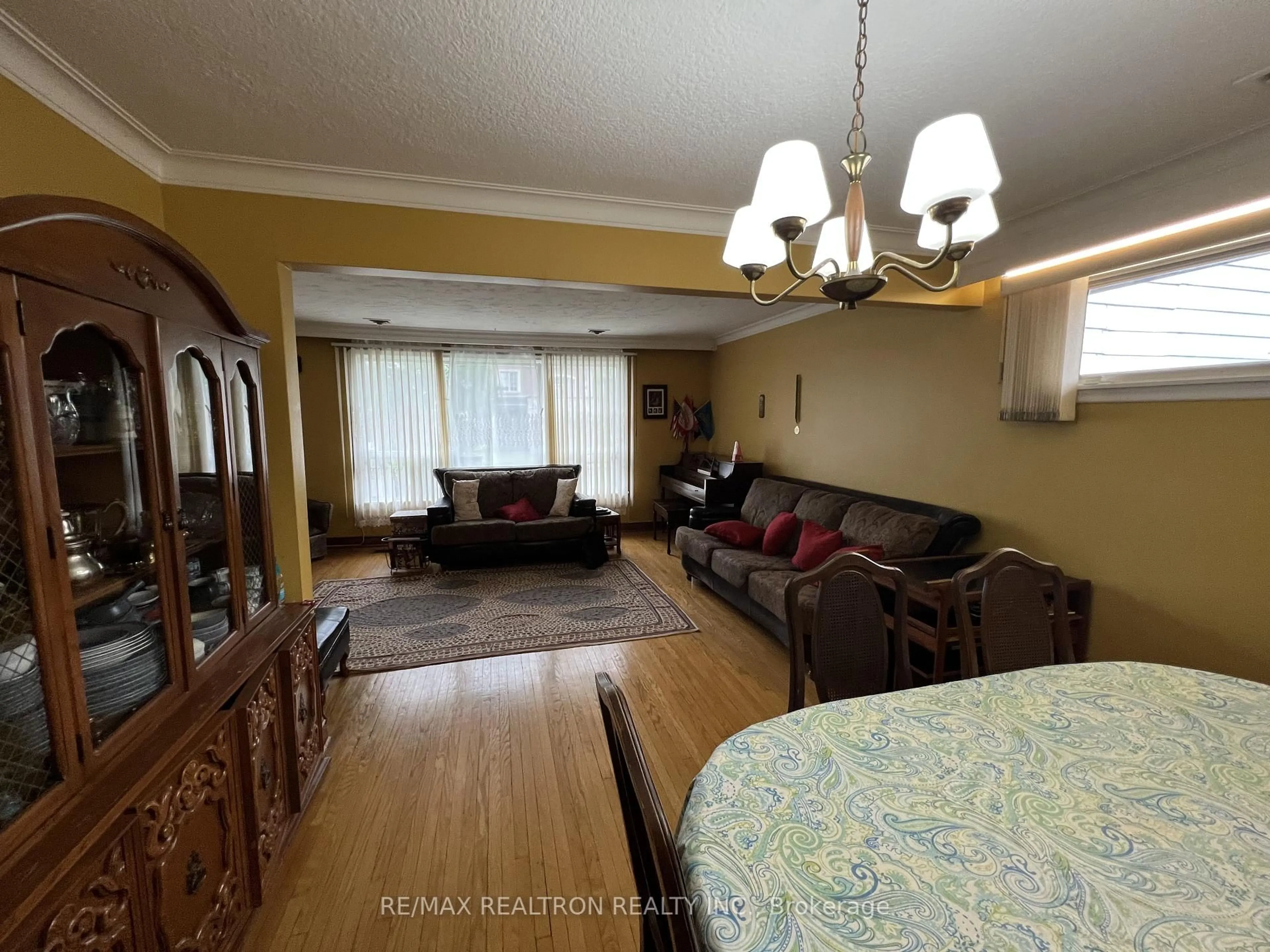 Living room with furniture, wood/laminate floor for 119 Regina Ave, Toronto Ontario M6A 1R8