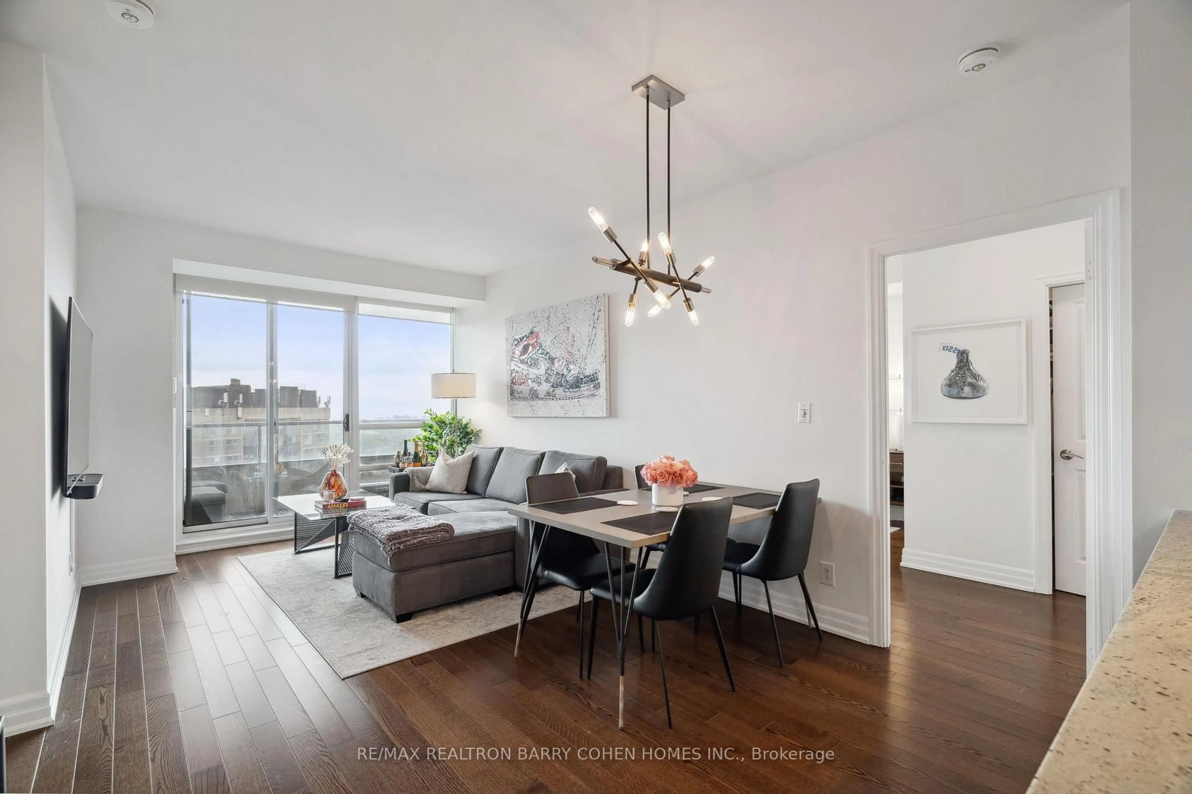 Living room with furniture, wood/laminate floor for 500 St Clair Ave #2007, Toronto Ontario M6C 1A8