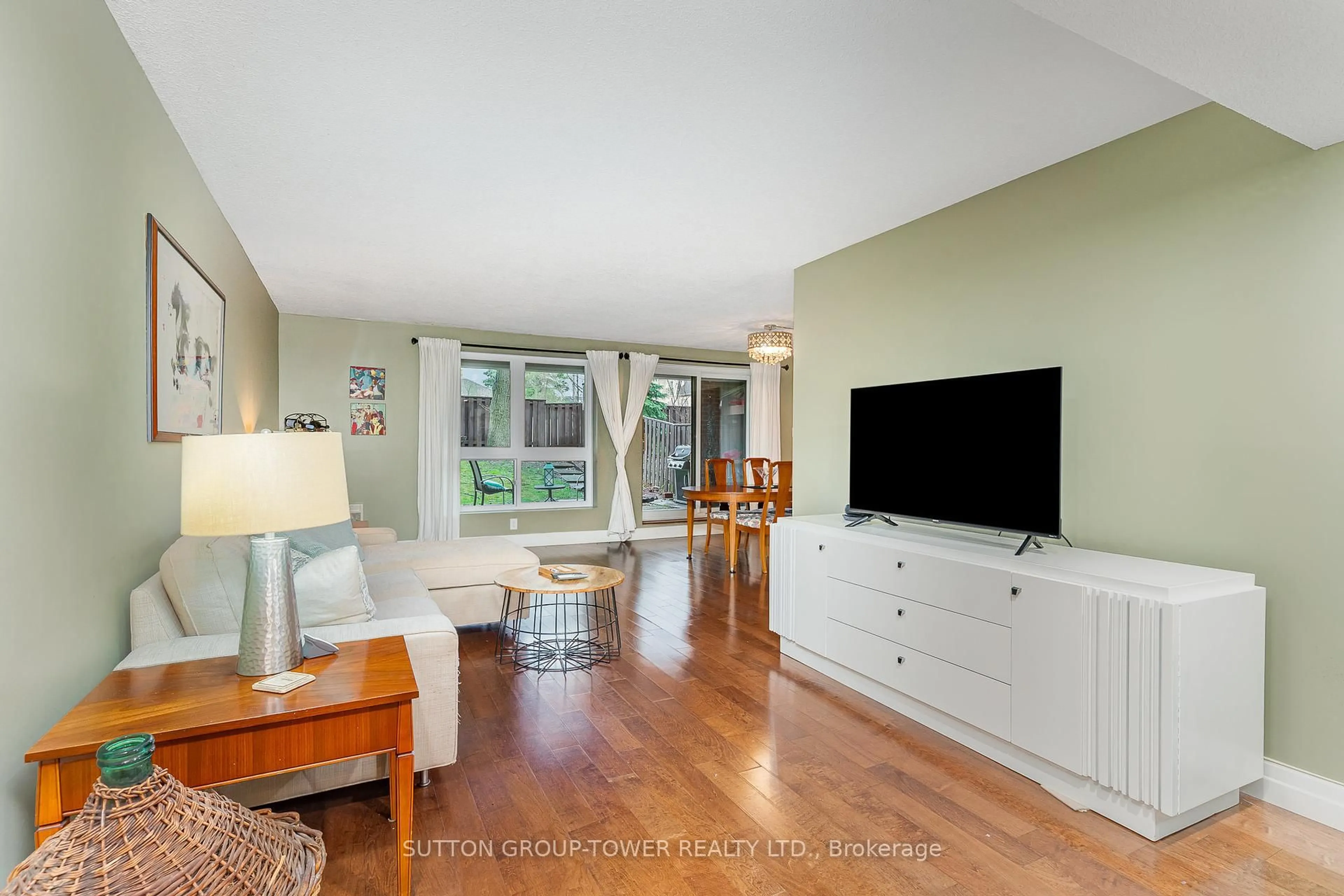Living room with furniture, wood/laminate floor for 55 Carscadden Dr #104, Toronto Ontario M2R 2A6