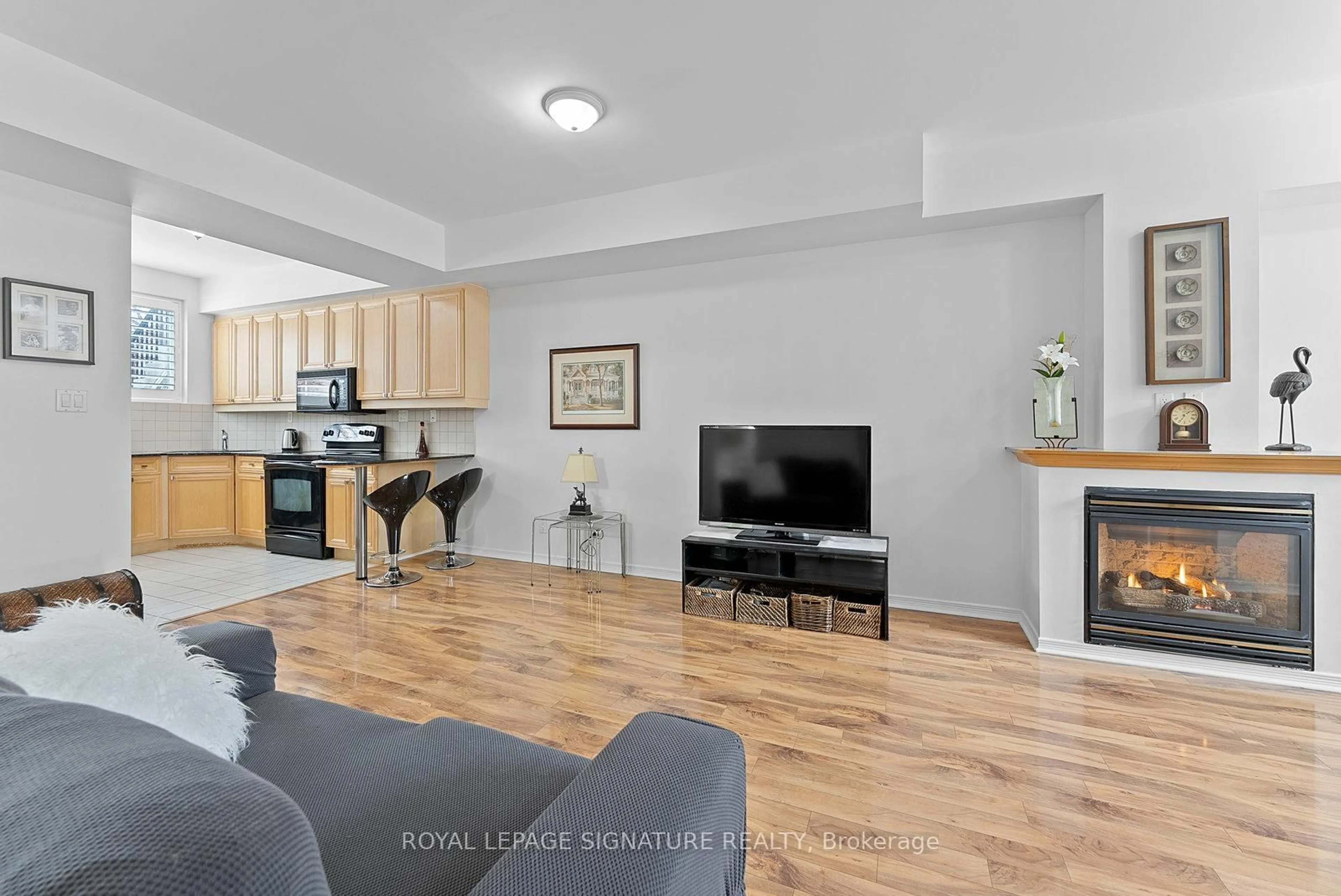 Living room with furniture, wood/laminate floor for 1785 Eglinton Ave #103, Toronto Ontario M4A 2Y6