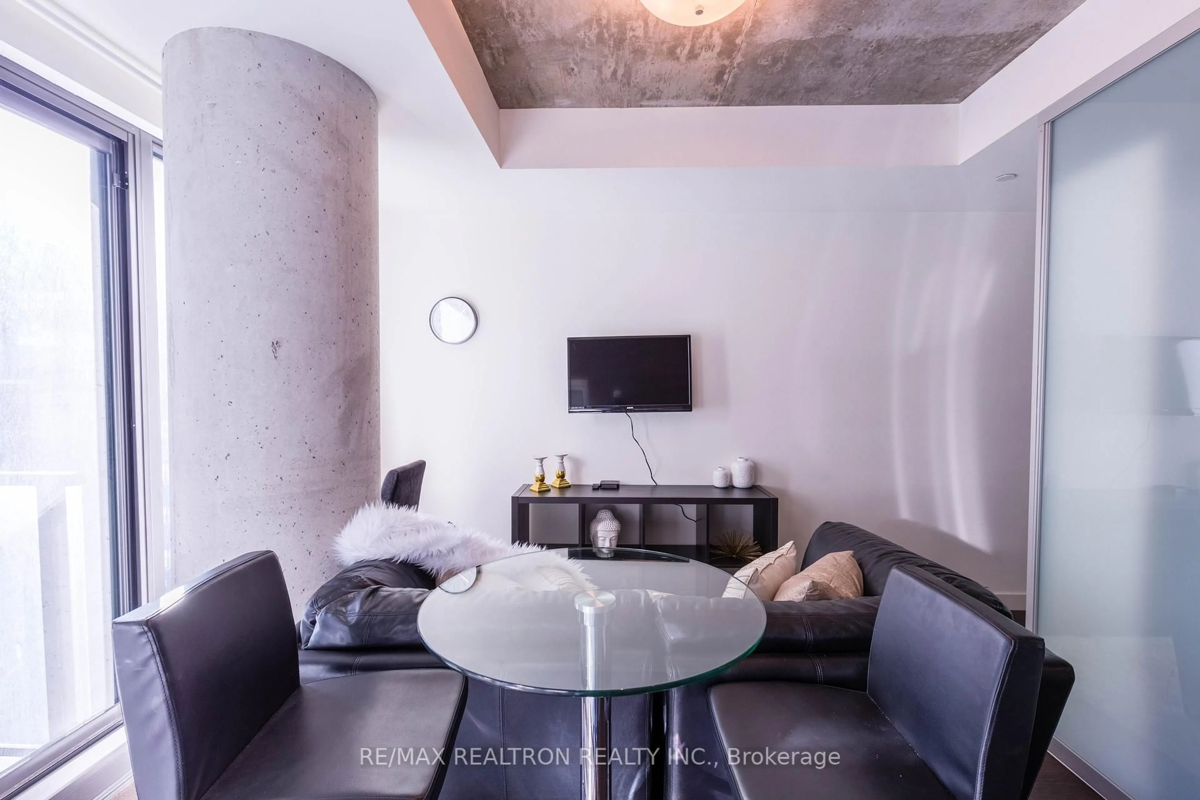 Living room with furniture, cement floor for 111 Bathurst St #1001, Toronto Ontario M5V 2R1