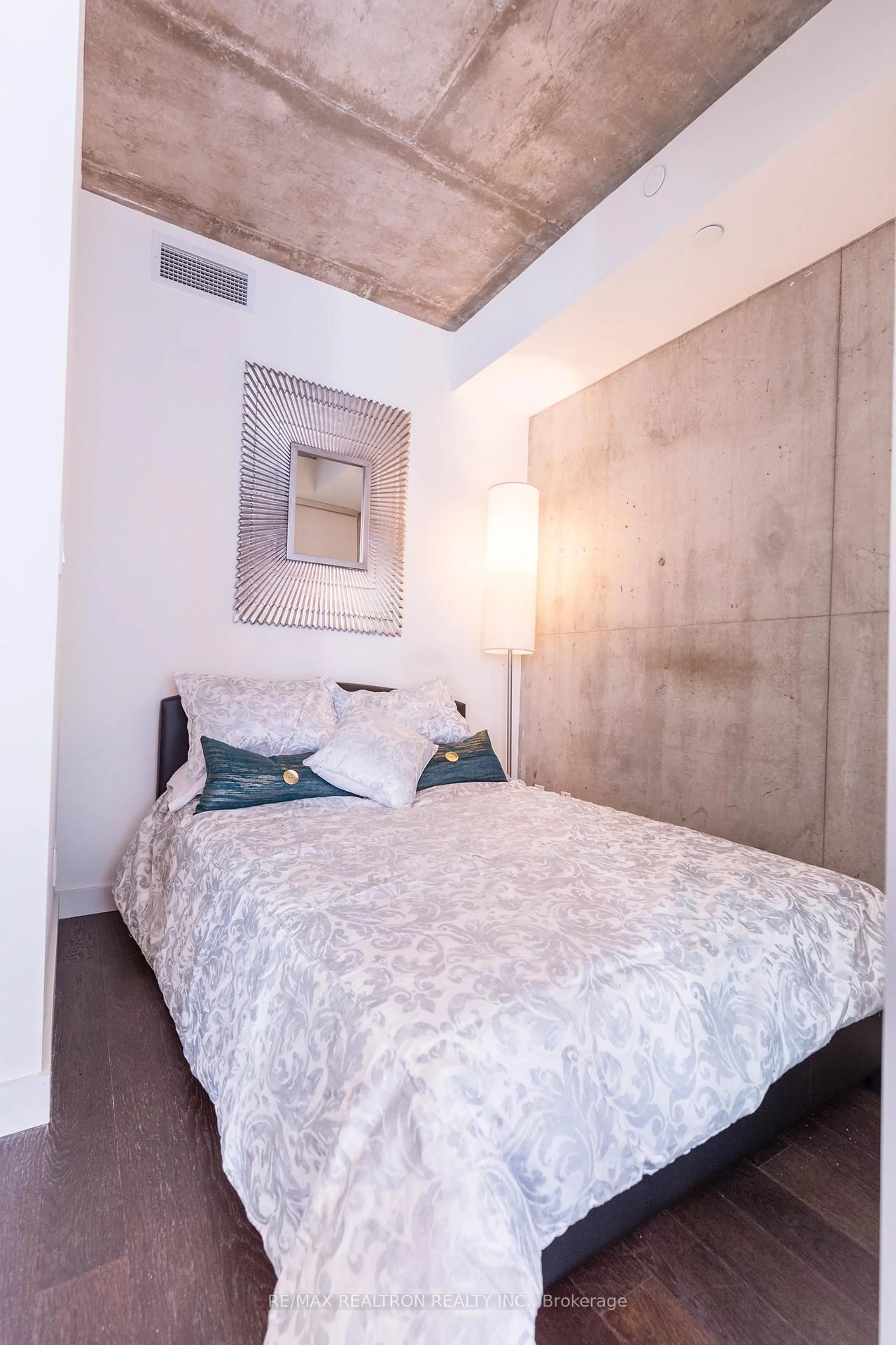 Bedroom with bed, cement floor for 111 Bathurst St #1001, Toronto Ontario M5V 2R1