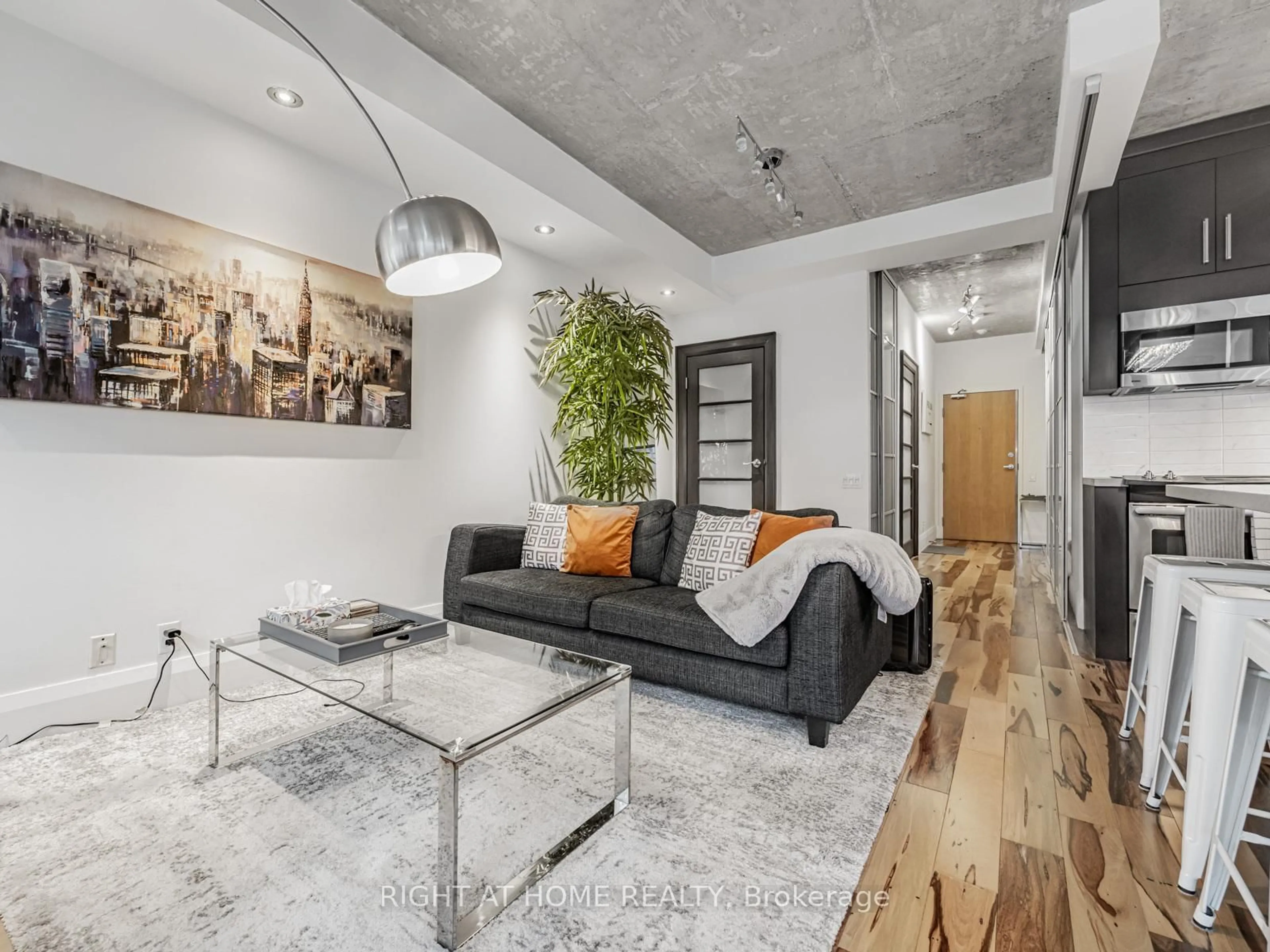 Living room with furniture, cement floor for 50 Camden St #405, Toronto Ontario M5V 3N1