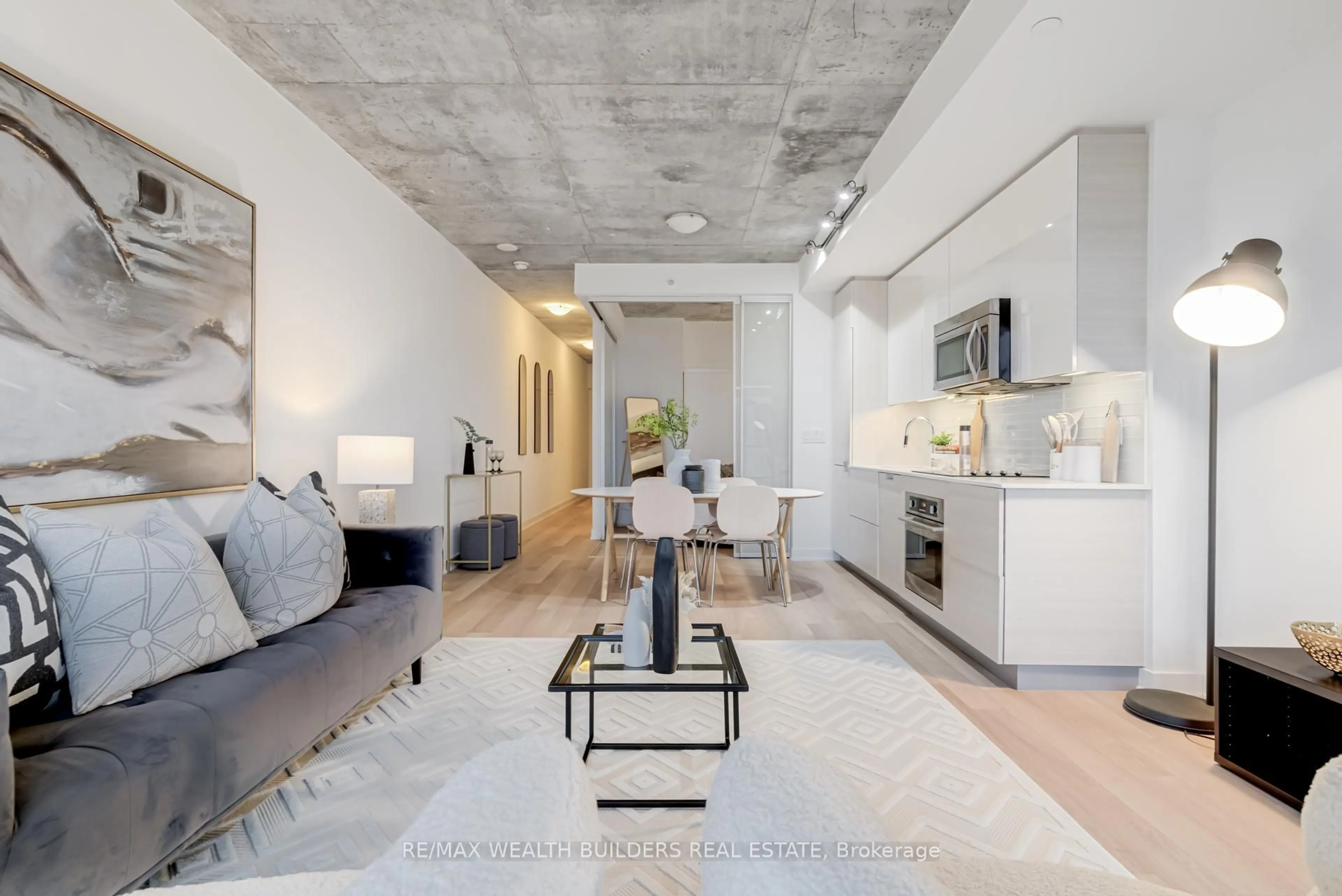 Living room with furniture, cement floor for 210 Simcoe St #1706, Toronto Ontario M5T 1T4