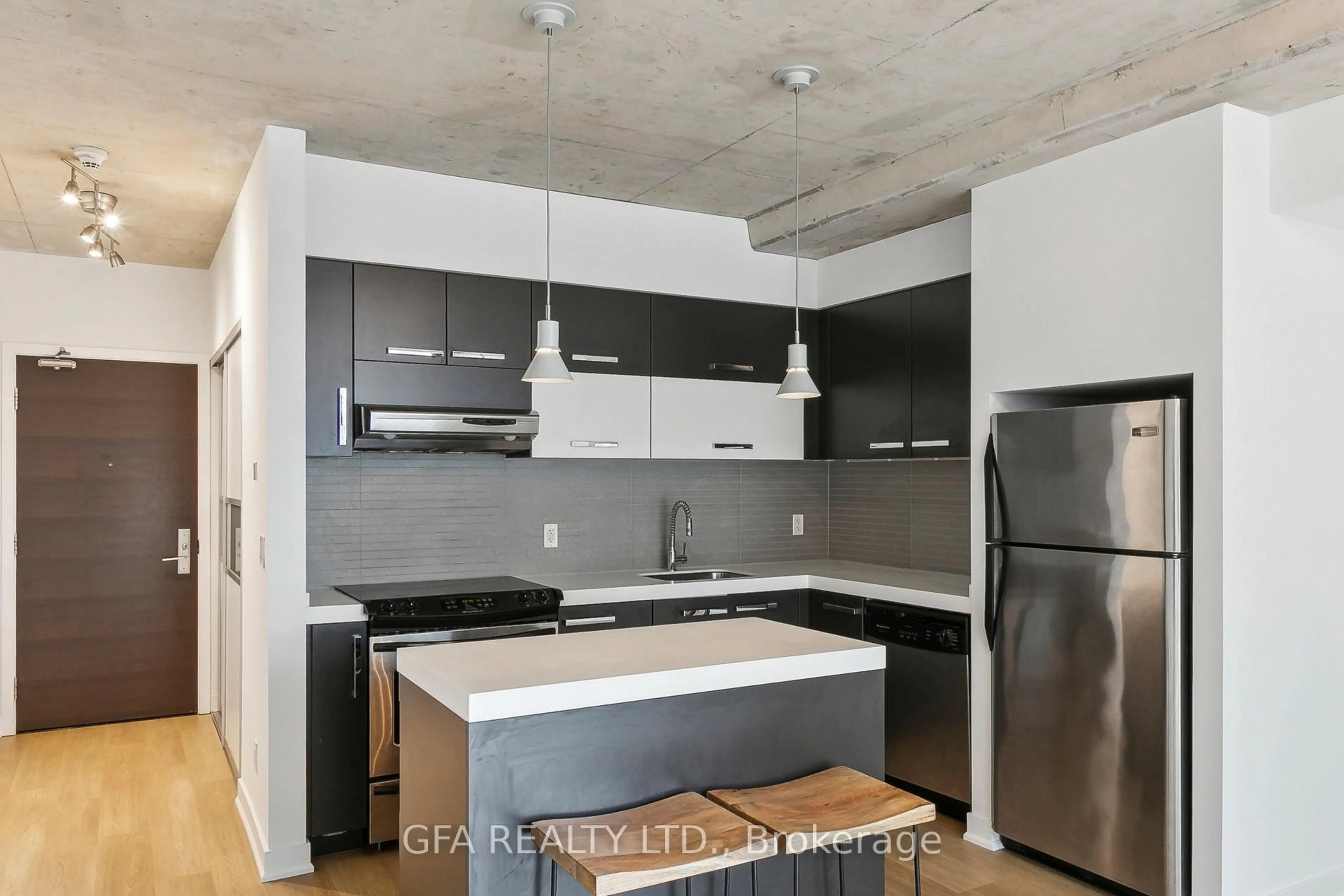 Open concept kitchen, cement floor for 55 Stewart St #413, Toronto Ontario M5V 2V1