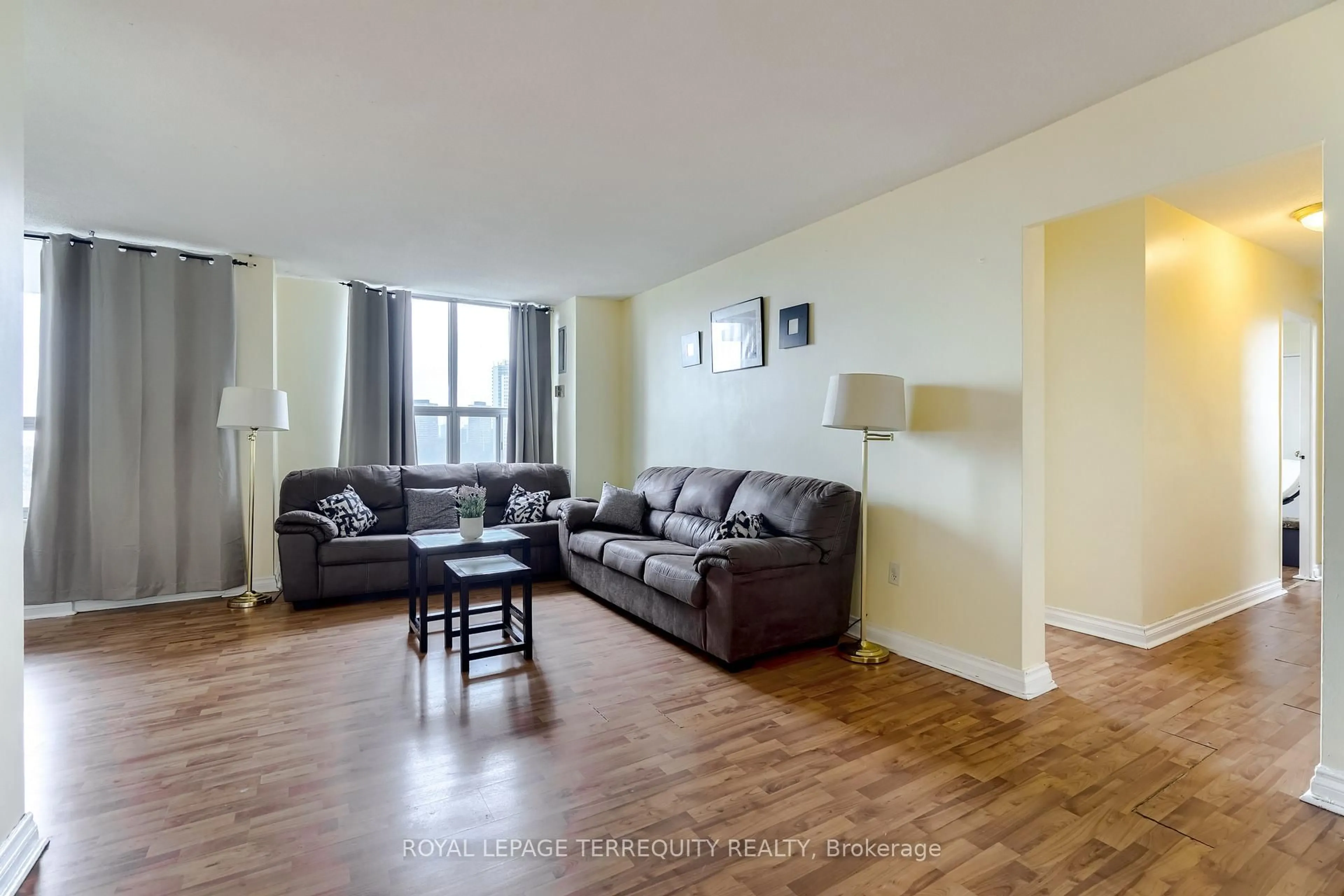 Living room with furniture, wood/laminate floor for 5 Shady Gfwy #904, Toronto Ontario M3C 3A5