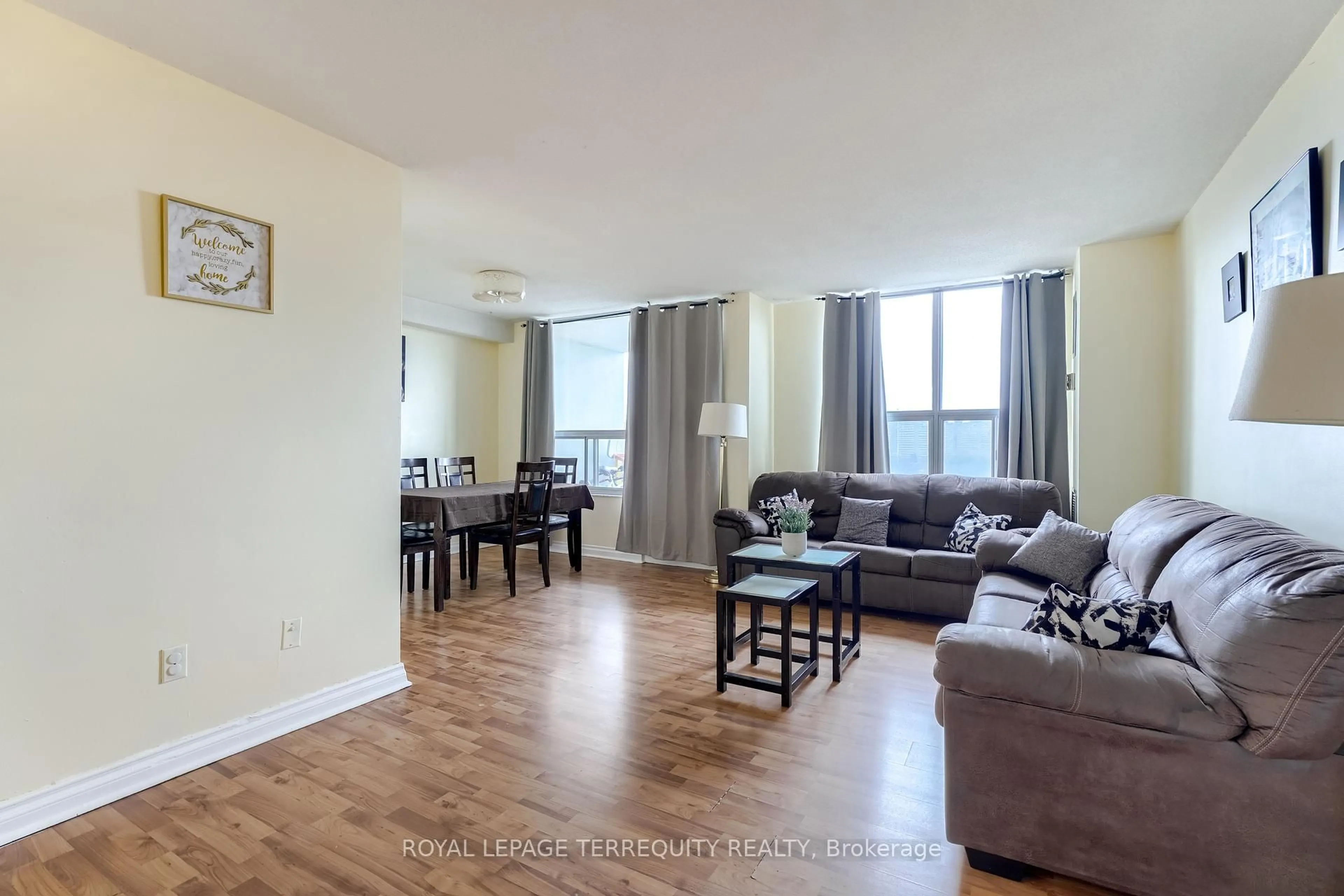 Living room with furniture, wood/laminate floor for 5 Shady Gfwy #904, Toronto Ontario M3C 3A5