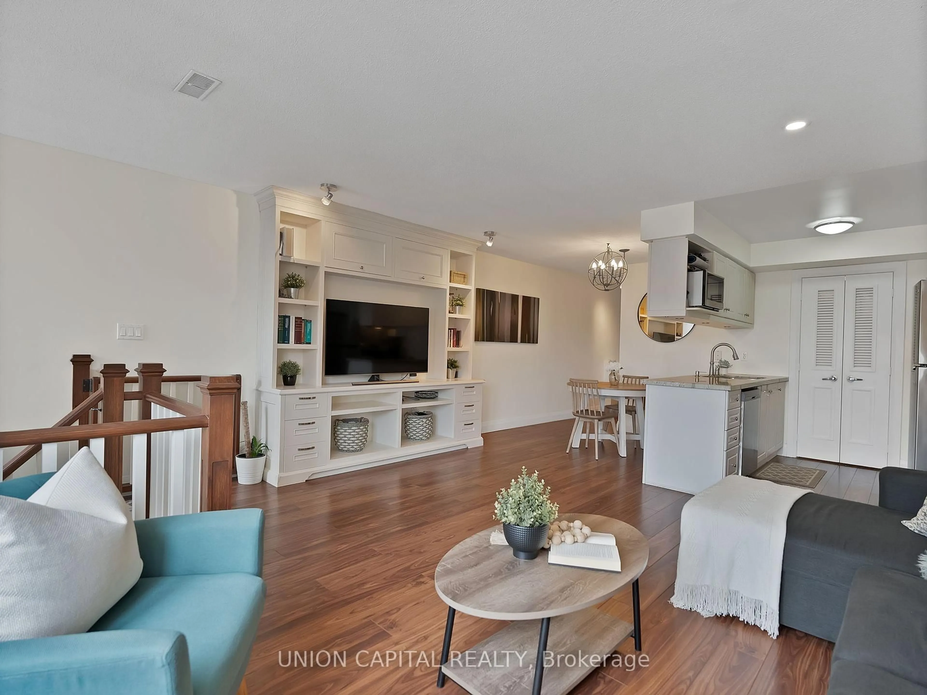 Living room with furniture, wood/laminate floor for 72 Aerodrome Cres #302, Toronto Ontario M4G 4J1