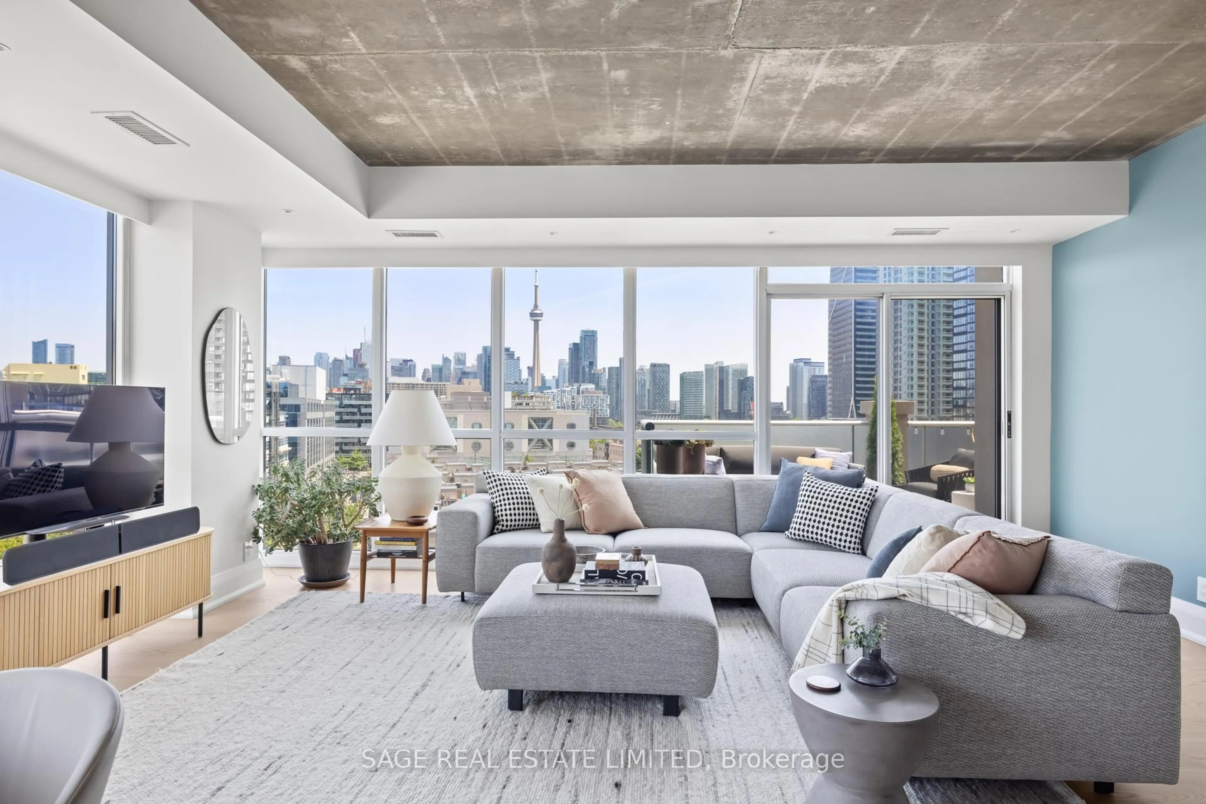 Living room with furniture, cement floor for 1 Shaw St #912, Toronto Ontario M6K 0A1