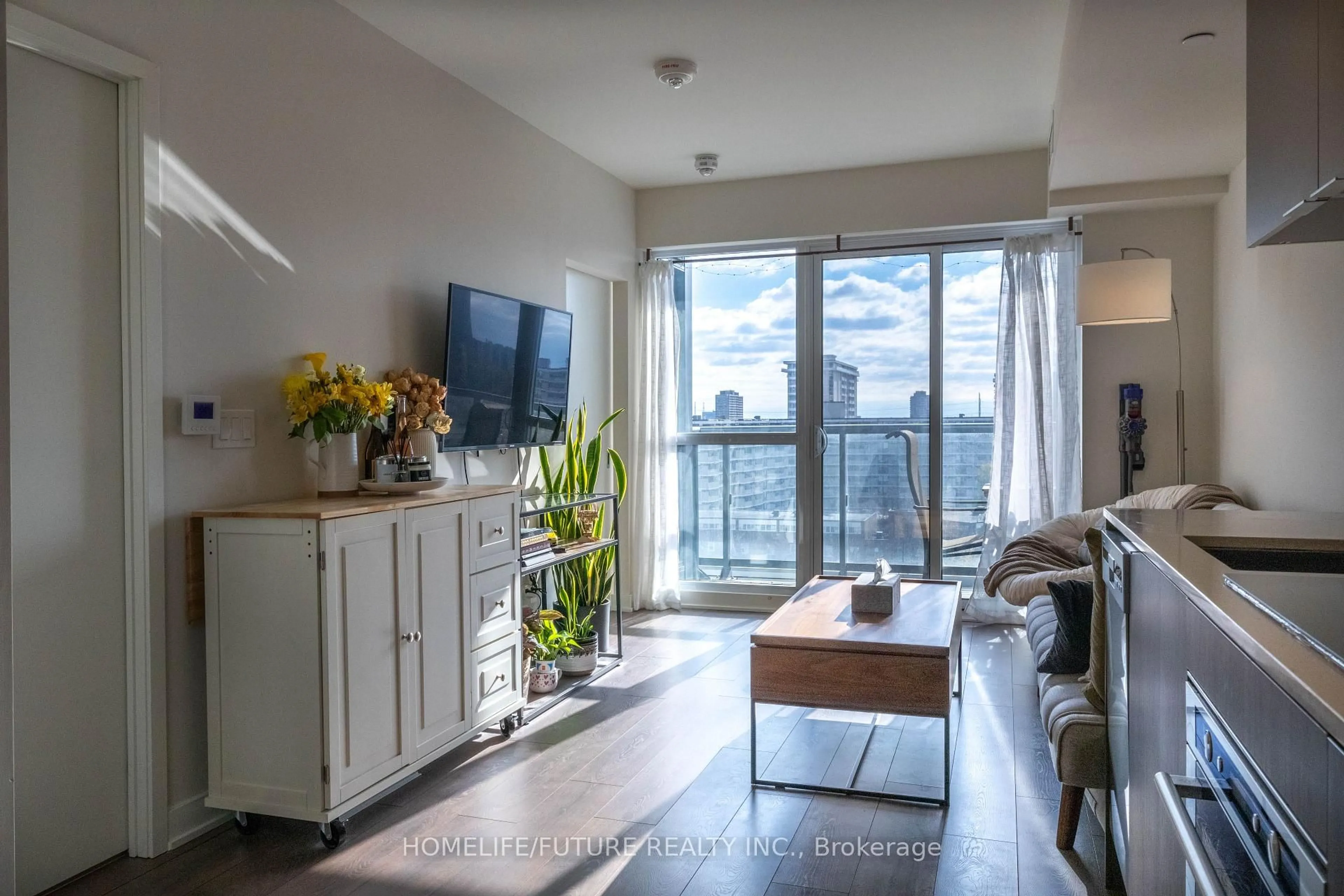 Living room with furniture, wood/laminate floor for 2 Sonic Way #908, Toronto Ontario M3C 0P2