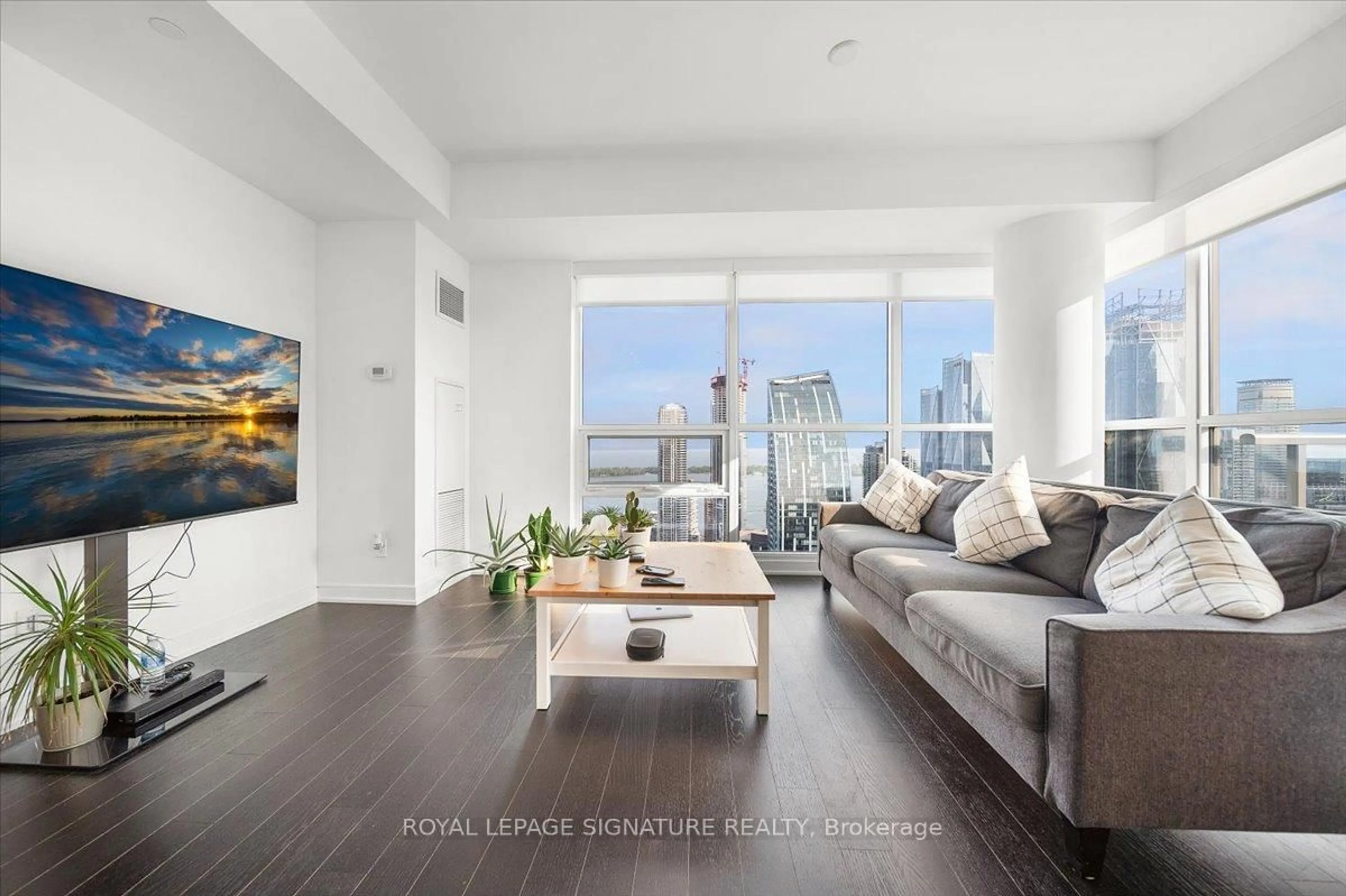 Living room with furniture, wood/laminate floor for 88 Scott St #5207, Toronto Ontario M5E 0A9