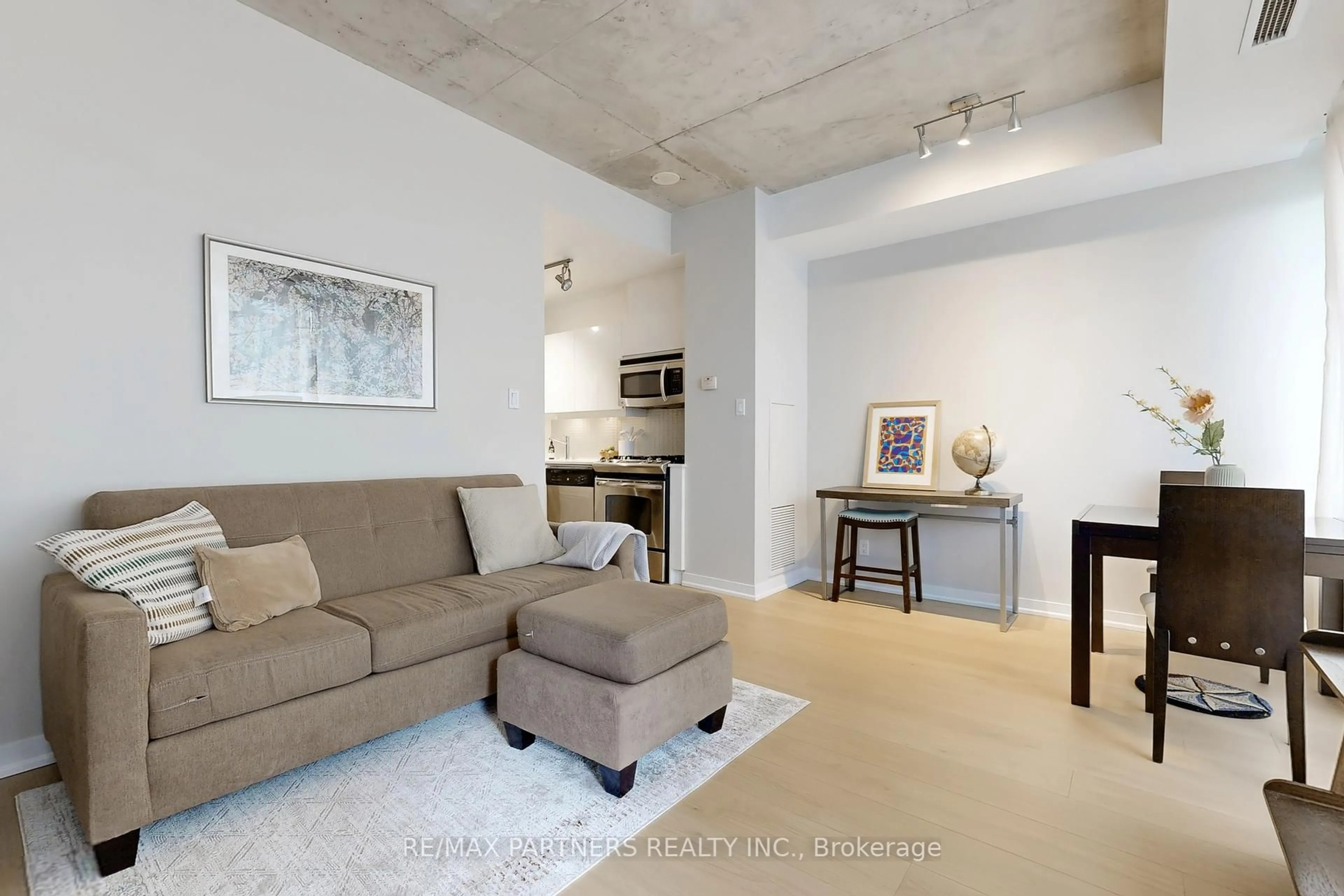 Living room with furniture, cement floor for 127 Queen St #604, Toronto Ontario M5C 1S3