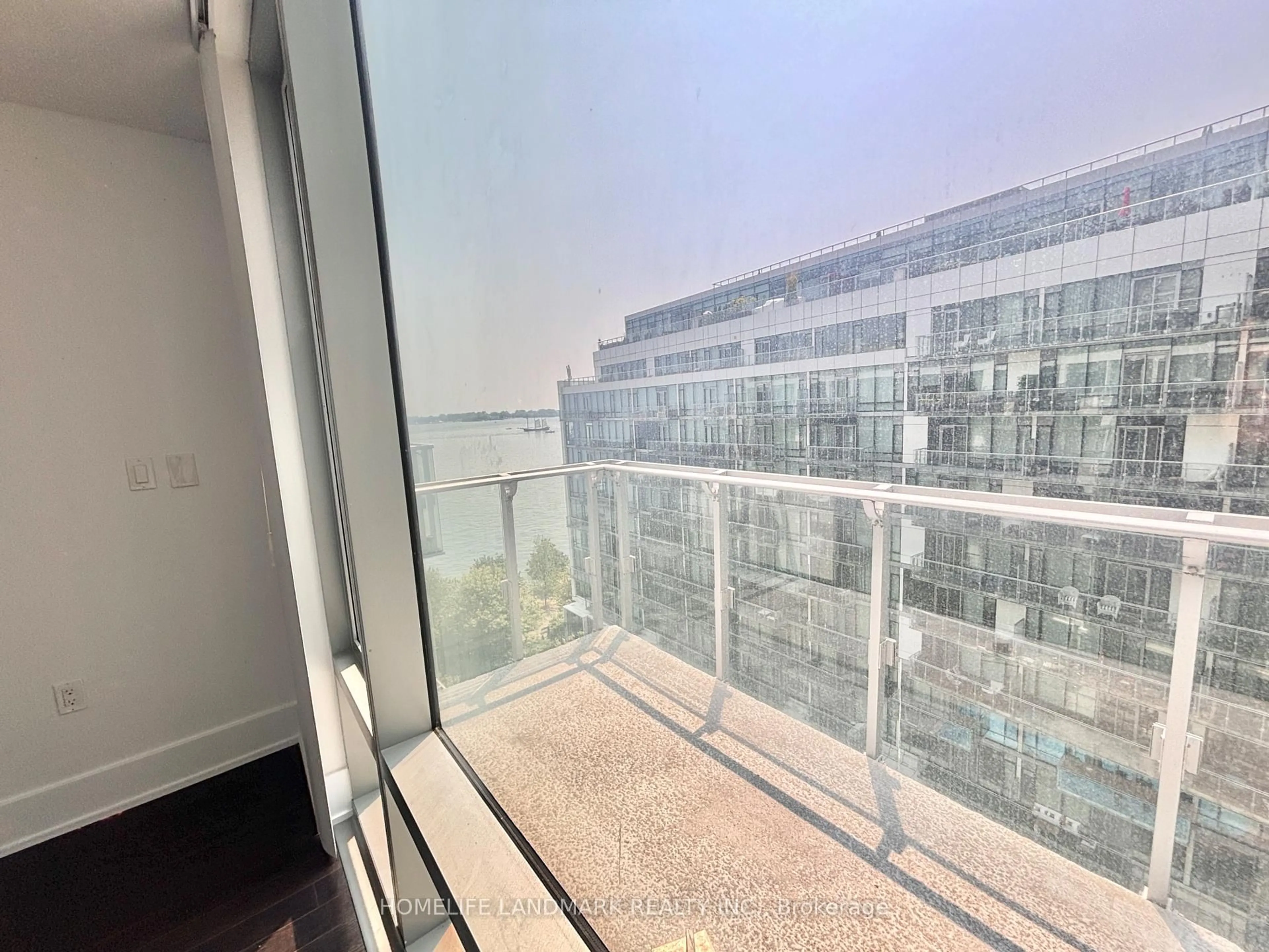 Balcony in the apartment, city buildings view from balcony for 39 Queens Quay #1029, Toronto Ontario M5E 0A5