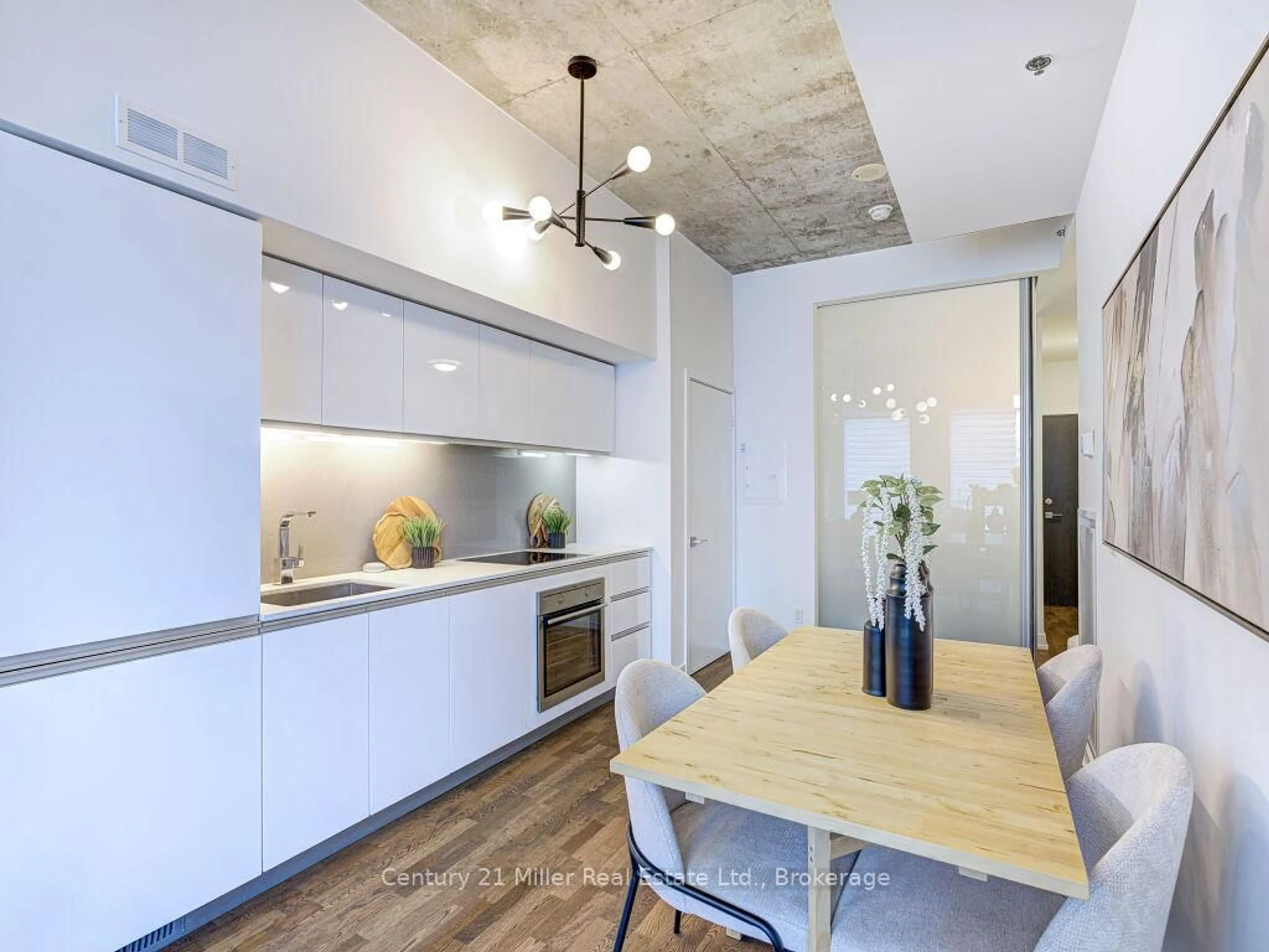 Open concept kitchen, cement floor for 20 Minowan Miikan Lane #313, Toronto Ontario M6J 0E5