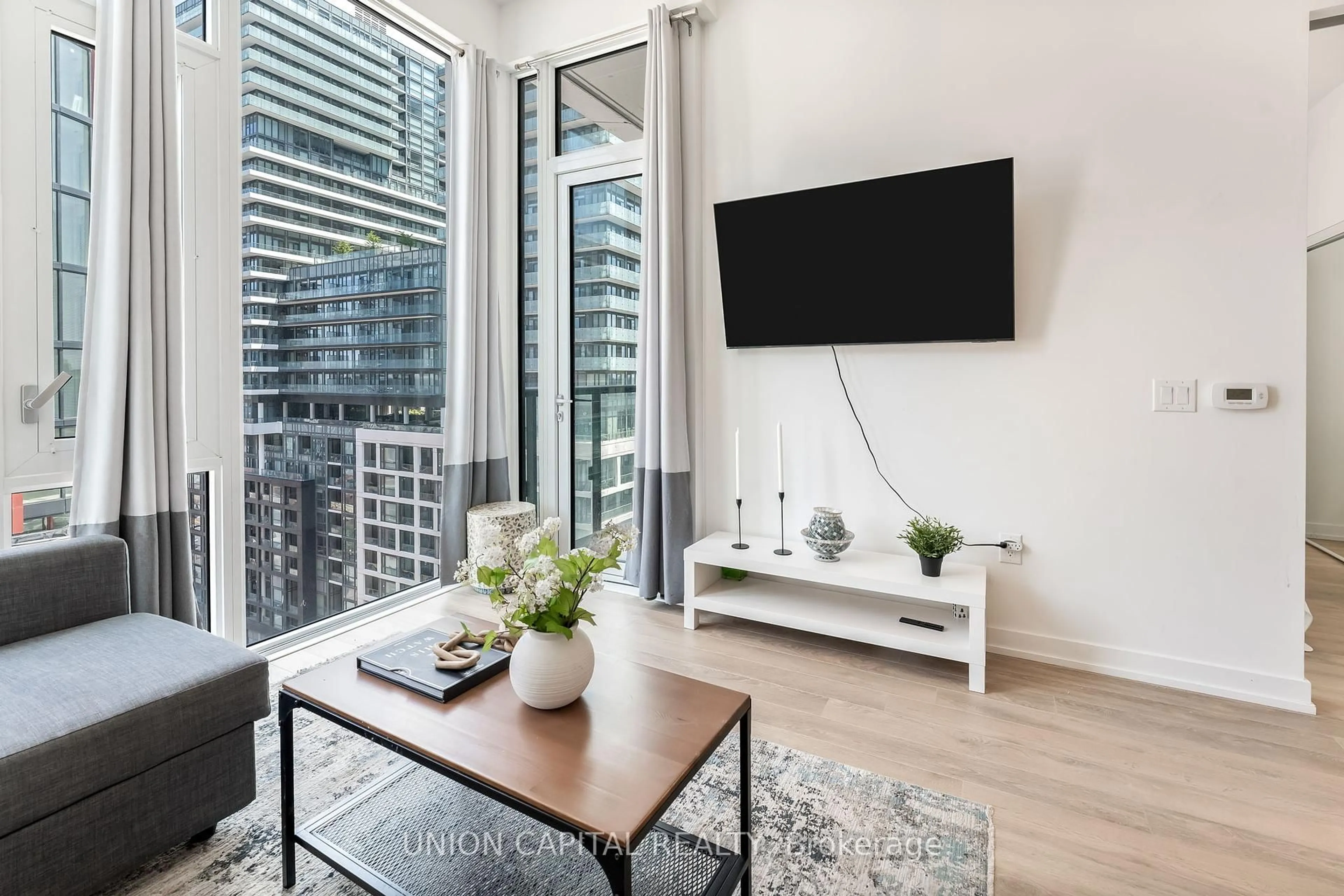 Living room with furniture, wood/laminate floor for 158 Front St #1313, Toronto Ontario M5A 0K9