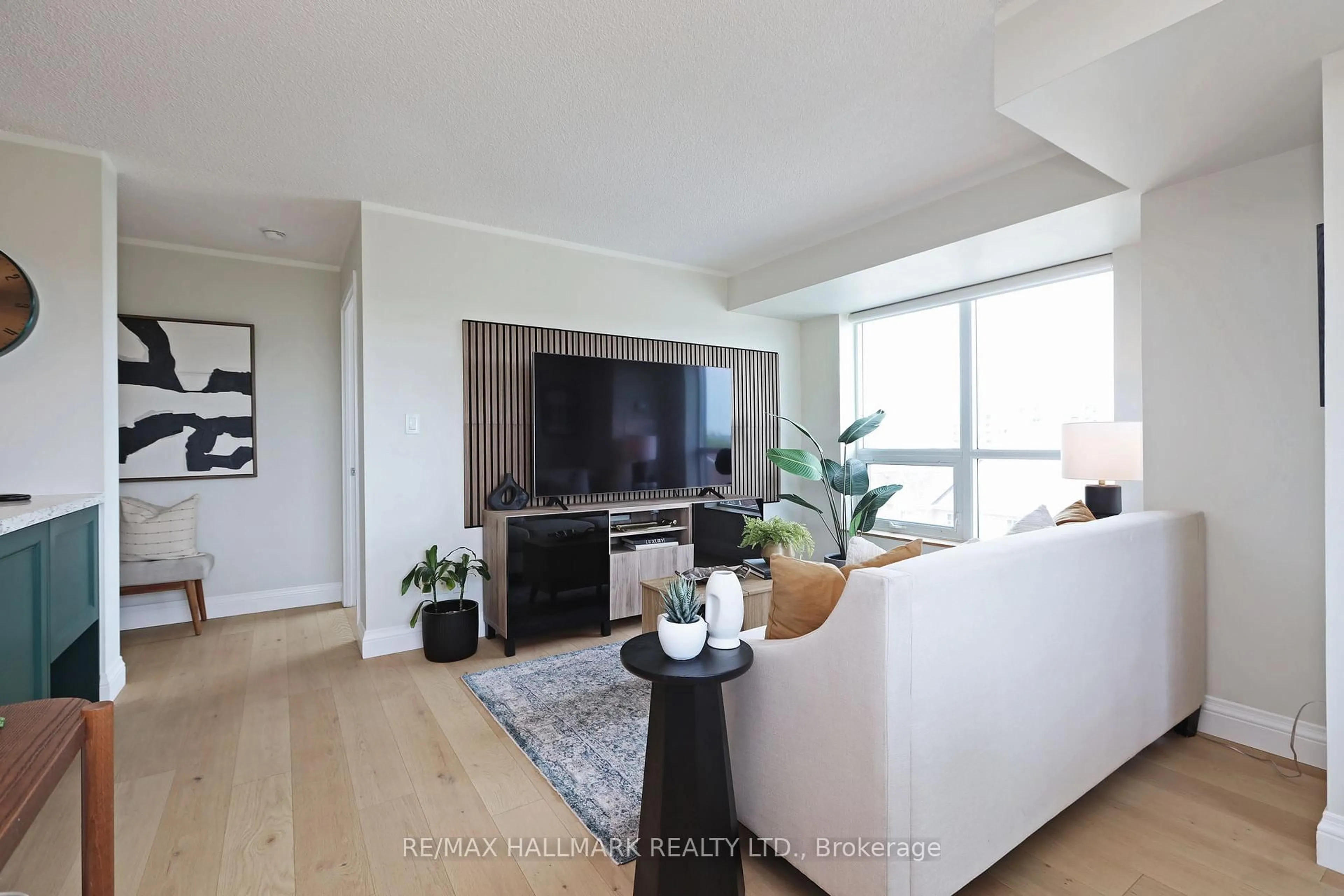 Living room with furniture, wood/laminate floor for 120 Dallimore Circ #407, Toronto Ontario M3C 4J1