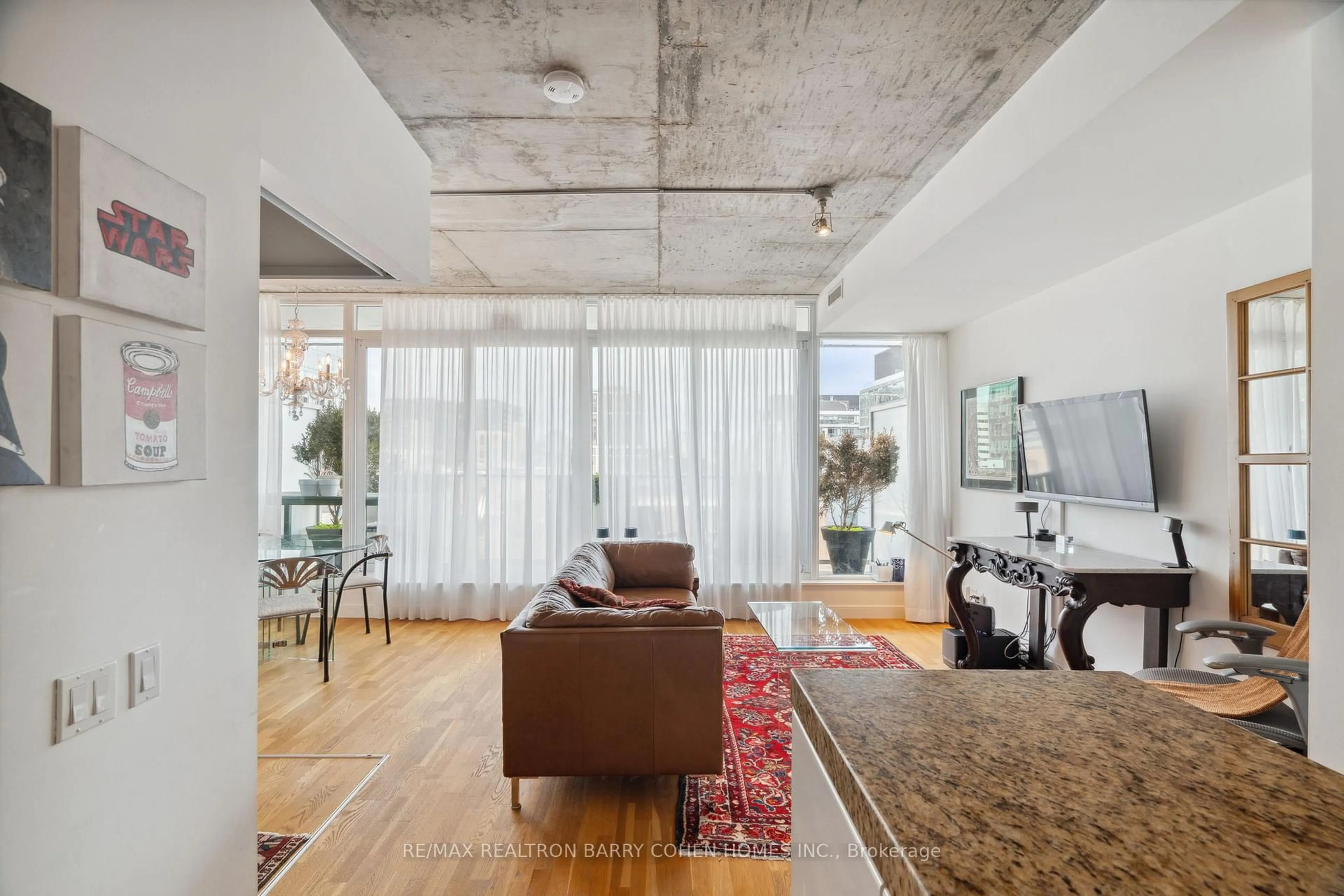 Living room with furniture, cement floor for 75 Portland St #911, Toronto Ontario M5V 2M9
