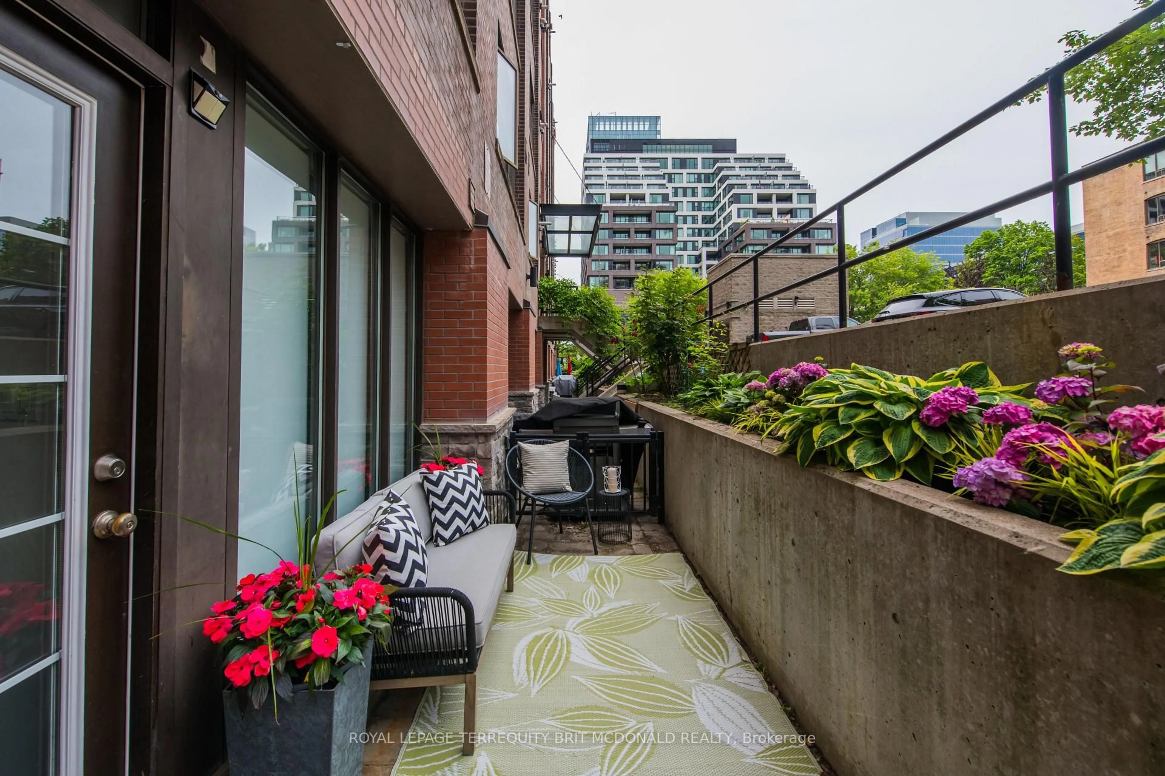 Patio, city buildings view from balcony for 436 Wellington St #108, Toronto Ontario M5V 1E3