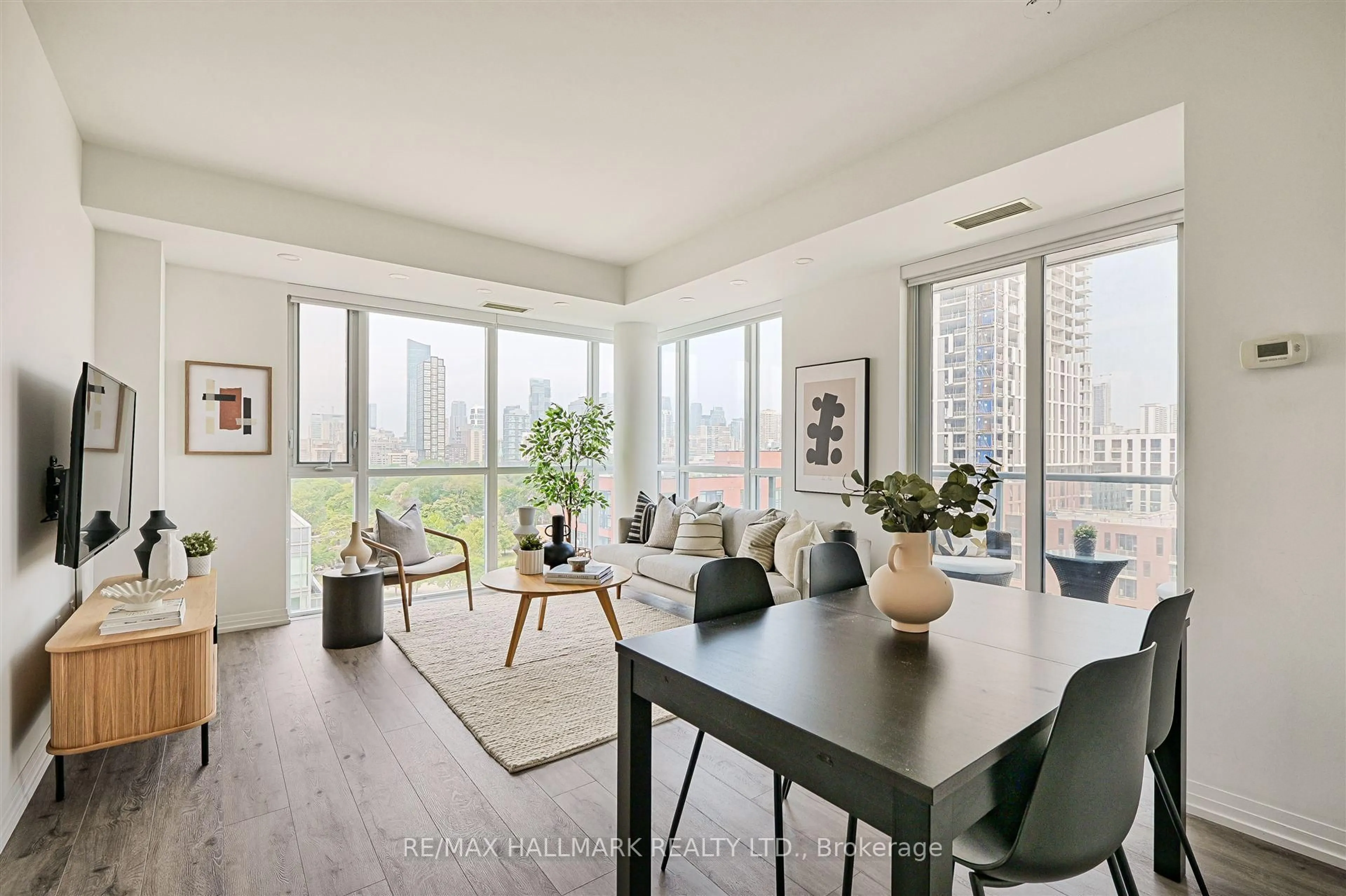 Living room with furniture, wood/laminate floor for 25 Cole St #1201, Toronto Ontario M5A 4M3