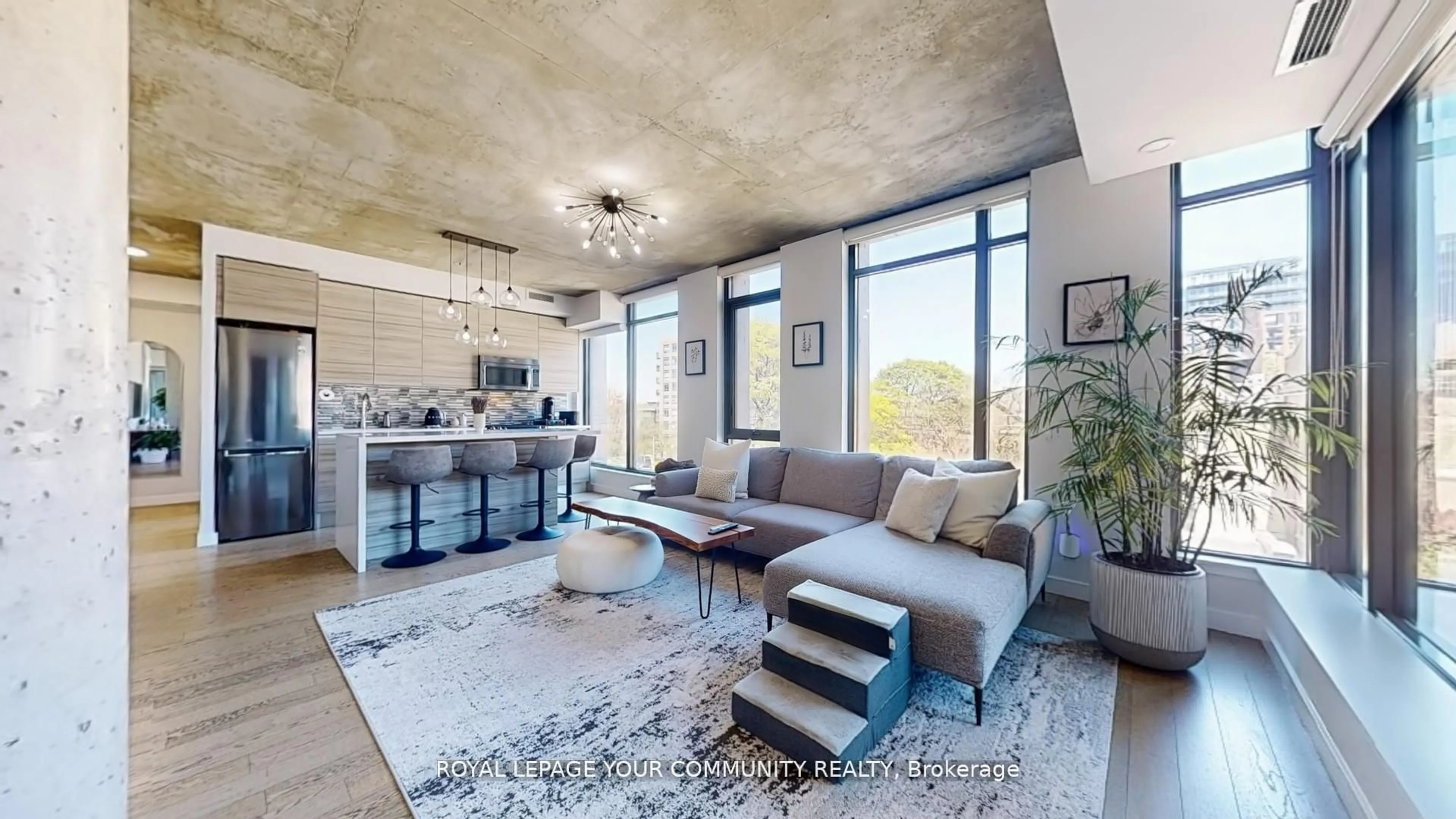 Living room with furniture, cement floor for 111 Bathurst St #314, Toronto Ontario M5V 0M9