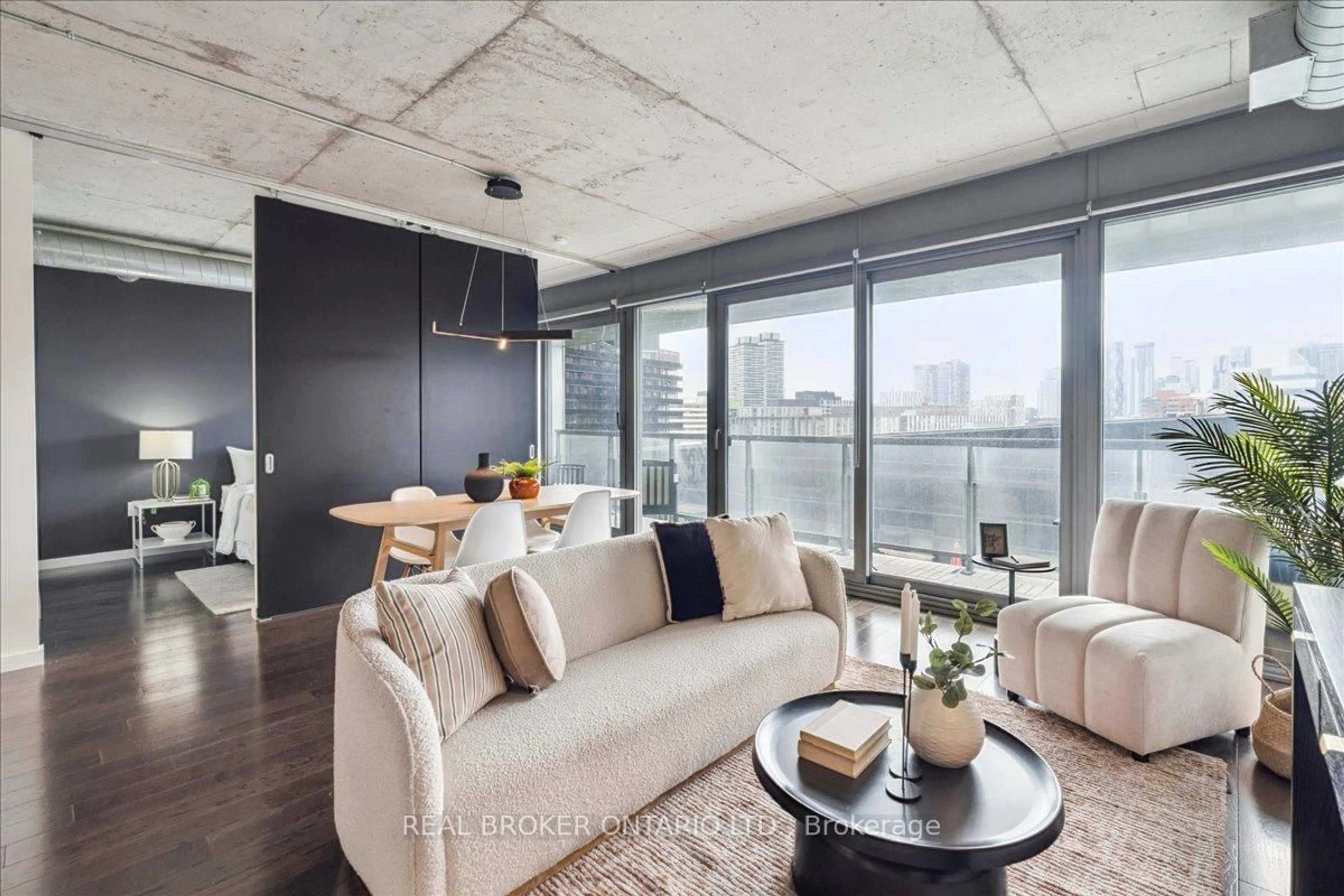Living room with furniture, cement floor for 32 Trolley Cres #812, Toronto Ontario M5A 0E8