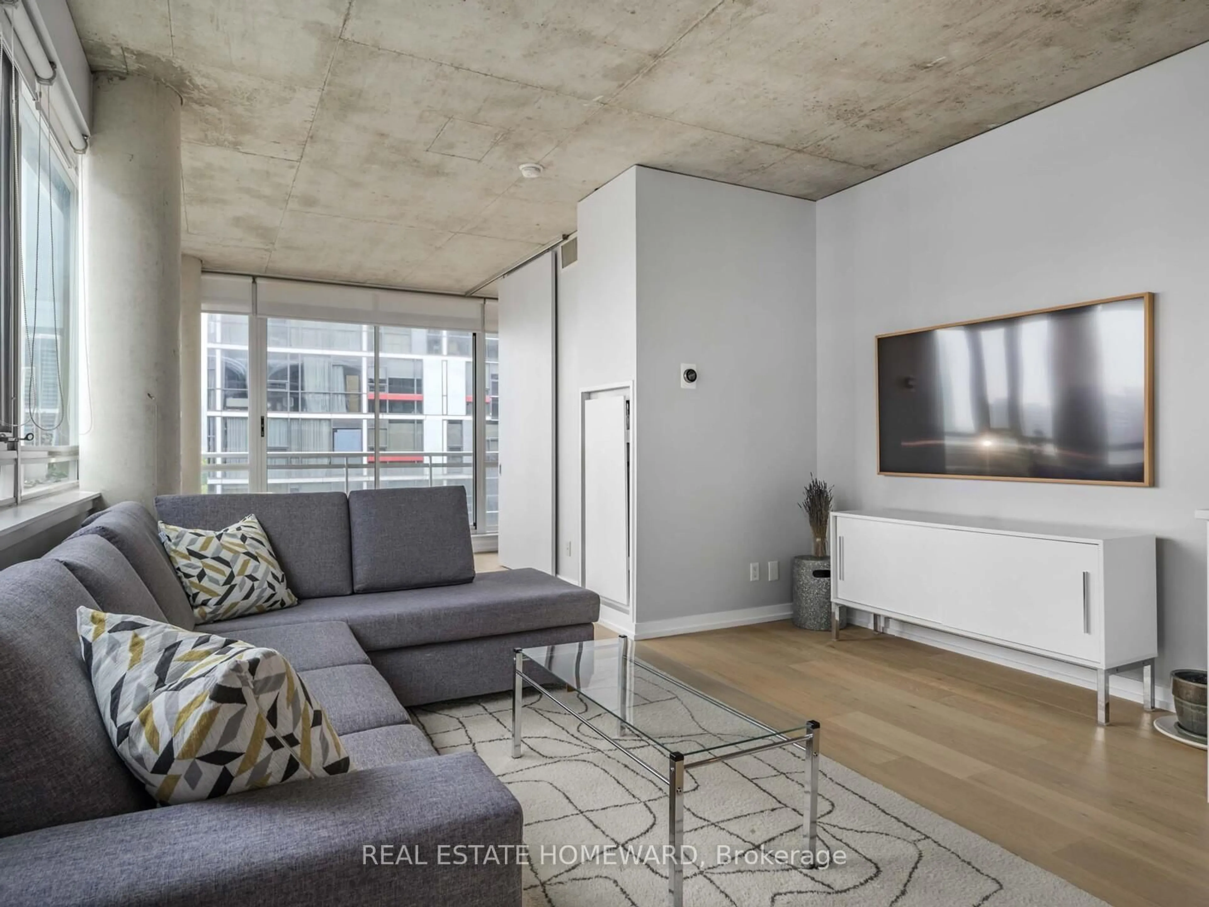 Living room with furniture, cement floor for 38 Niagara St #706, Toronto Ontario M5V 3X1