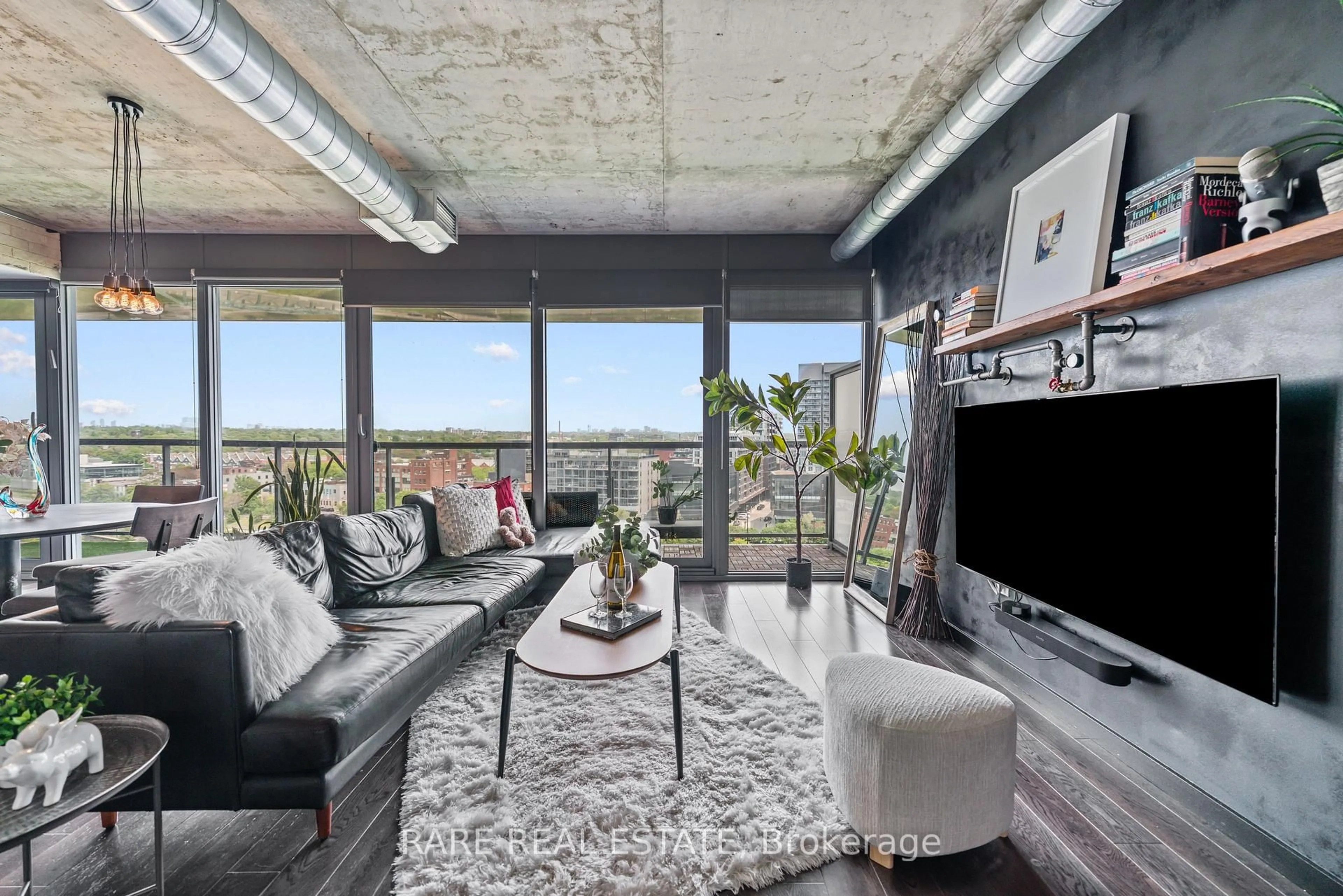 Living room with furniture, cement floor for 32 Trolley Cres #1125, Toronto Ontario M5A 0E8