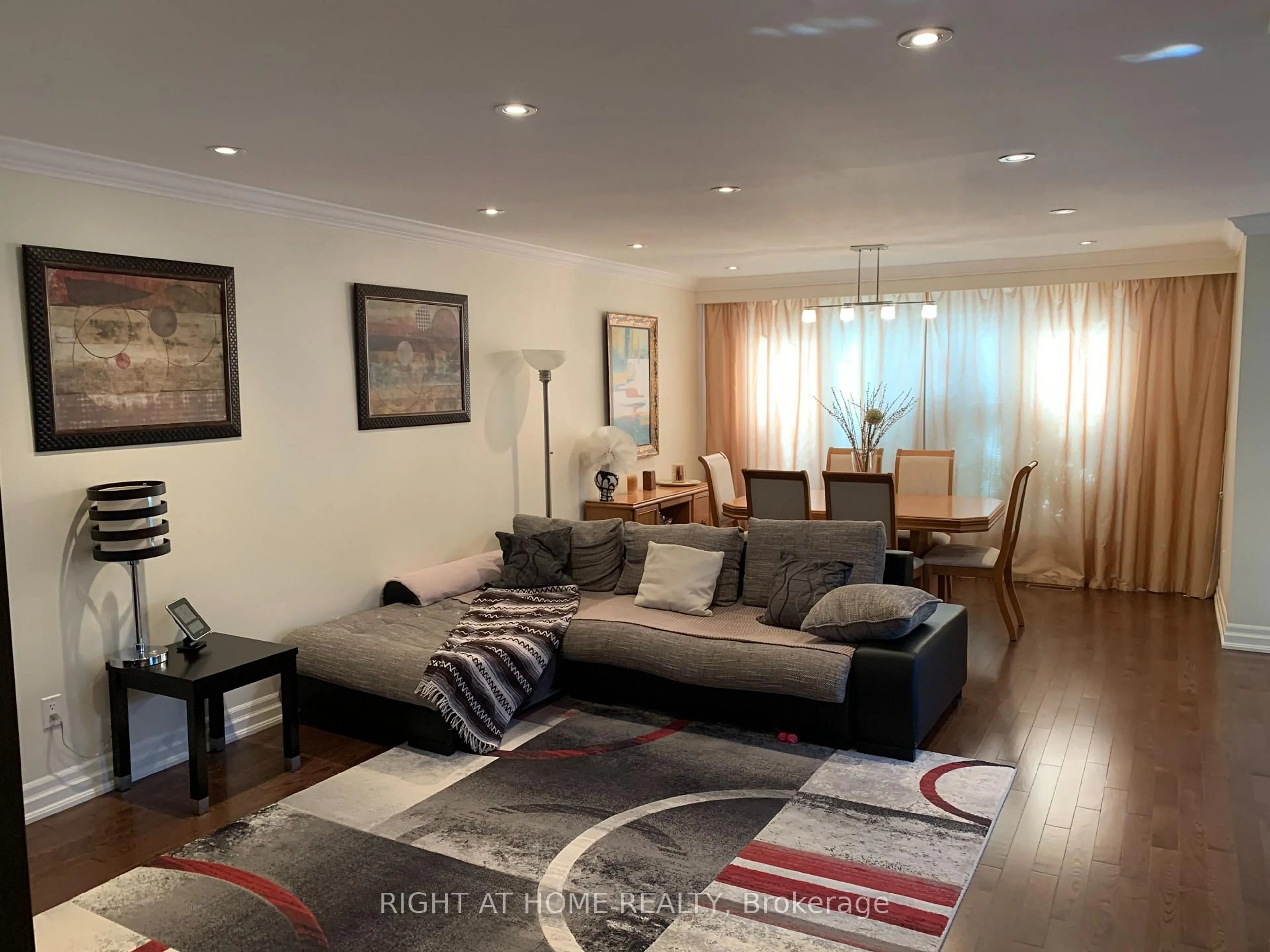 Living room with furniture, wood/laminate floor for 66 Dewlane Dr, Toronto Ontario M2R 2P8