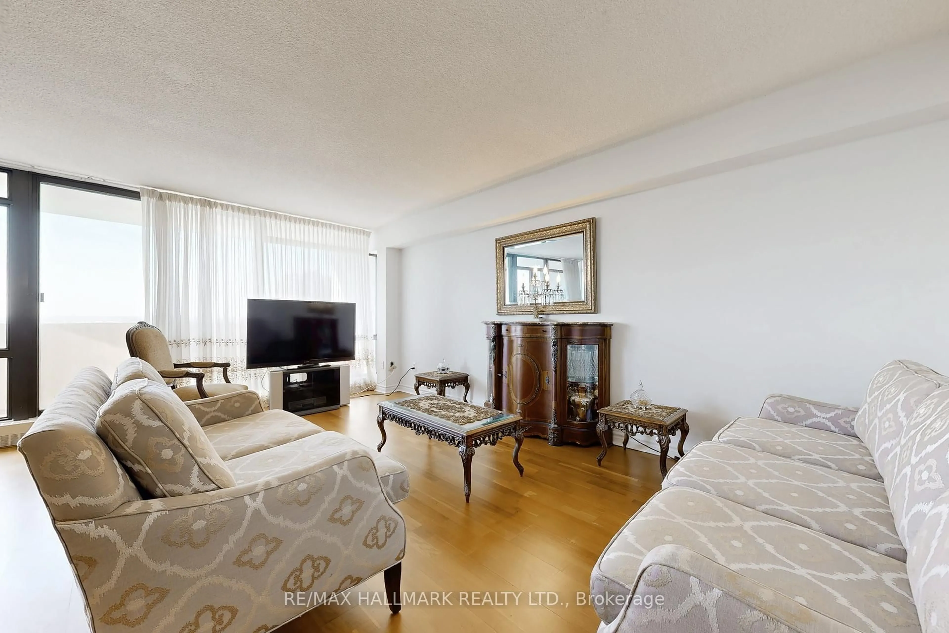 Living room with furniture, wood/laminate floor for 3300 Don Mills Rd Rd #1802, Toronto Ontario M2J 4X7