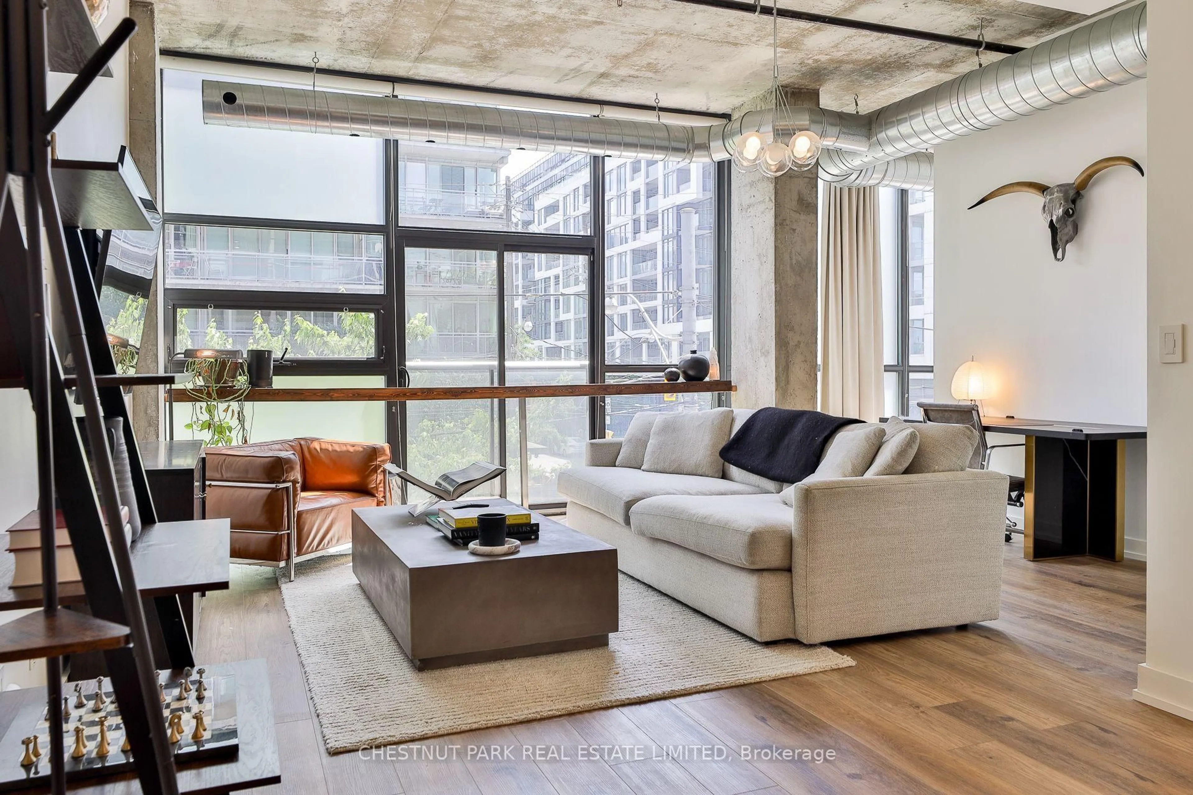 Living room with furniture, cement floor for 60 Bathurst St #211, Toronto Ontario M5V 2P4