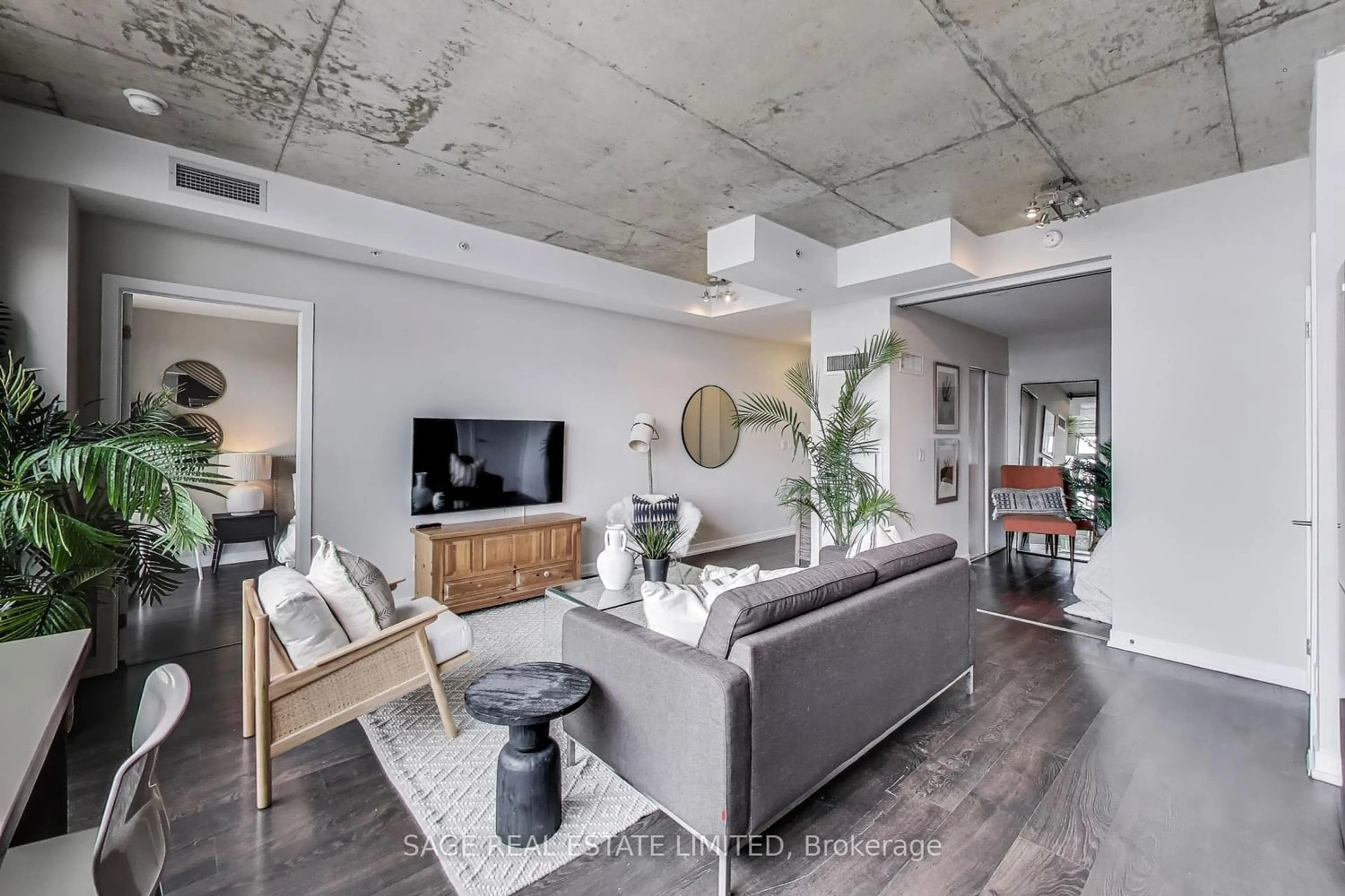 Living room with furniture, cement floor for 1205 Queen St #604, Toronto Ontario M6K 1L2