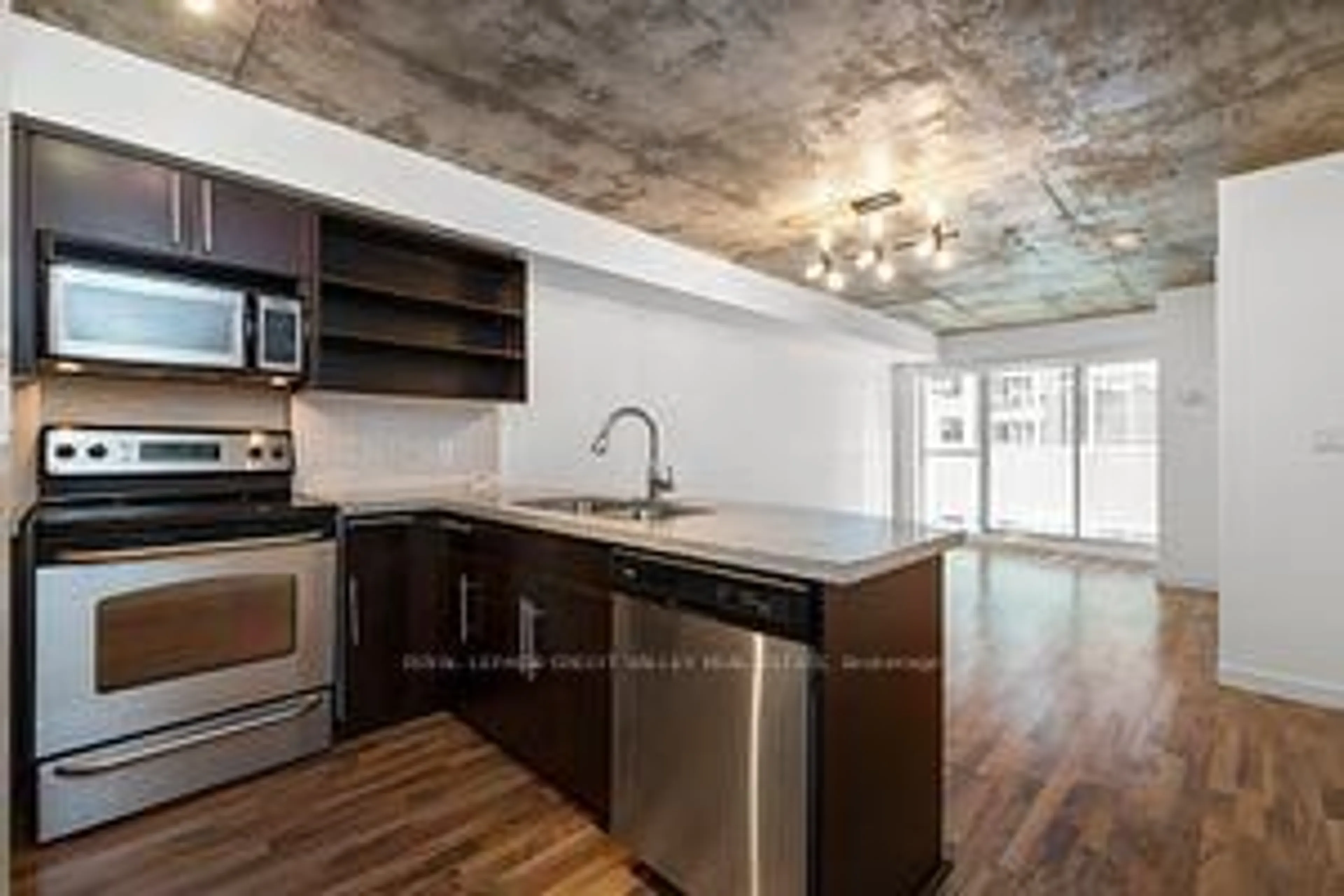 Open concept kitchen, cement floor for 1005 King St #505, Toronto Ontario M6K 3M8