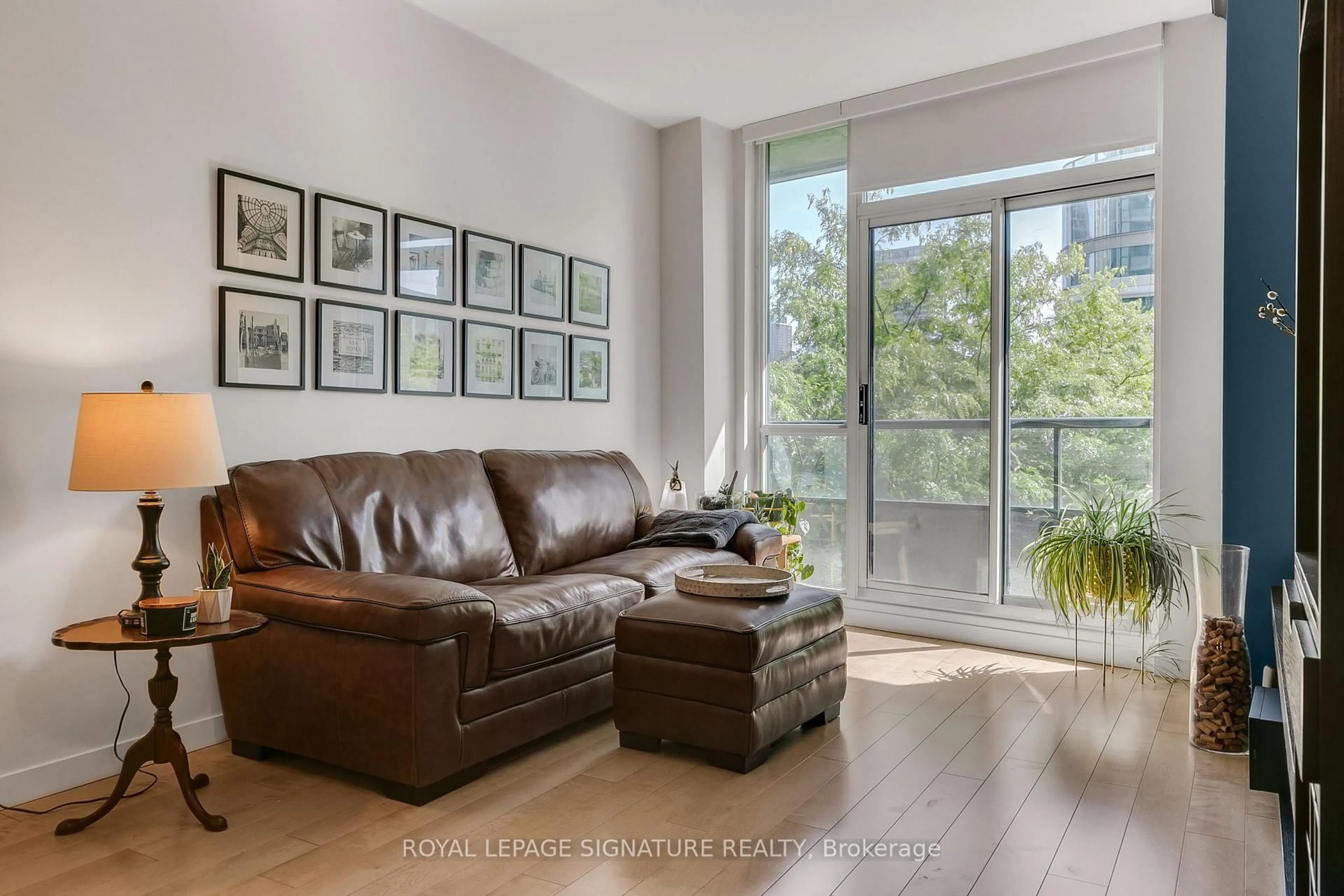 Living room with furniture, wood/laminate floor for 16 Yonge St #306, Toronto Ontario M5E 2A1