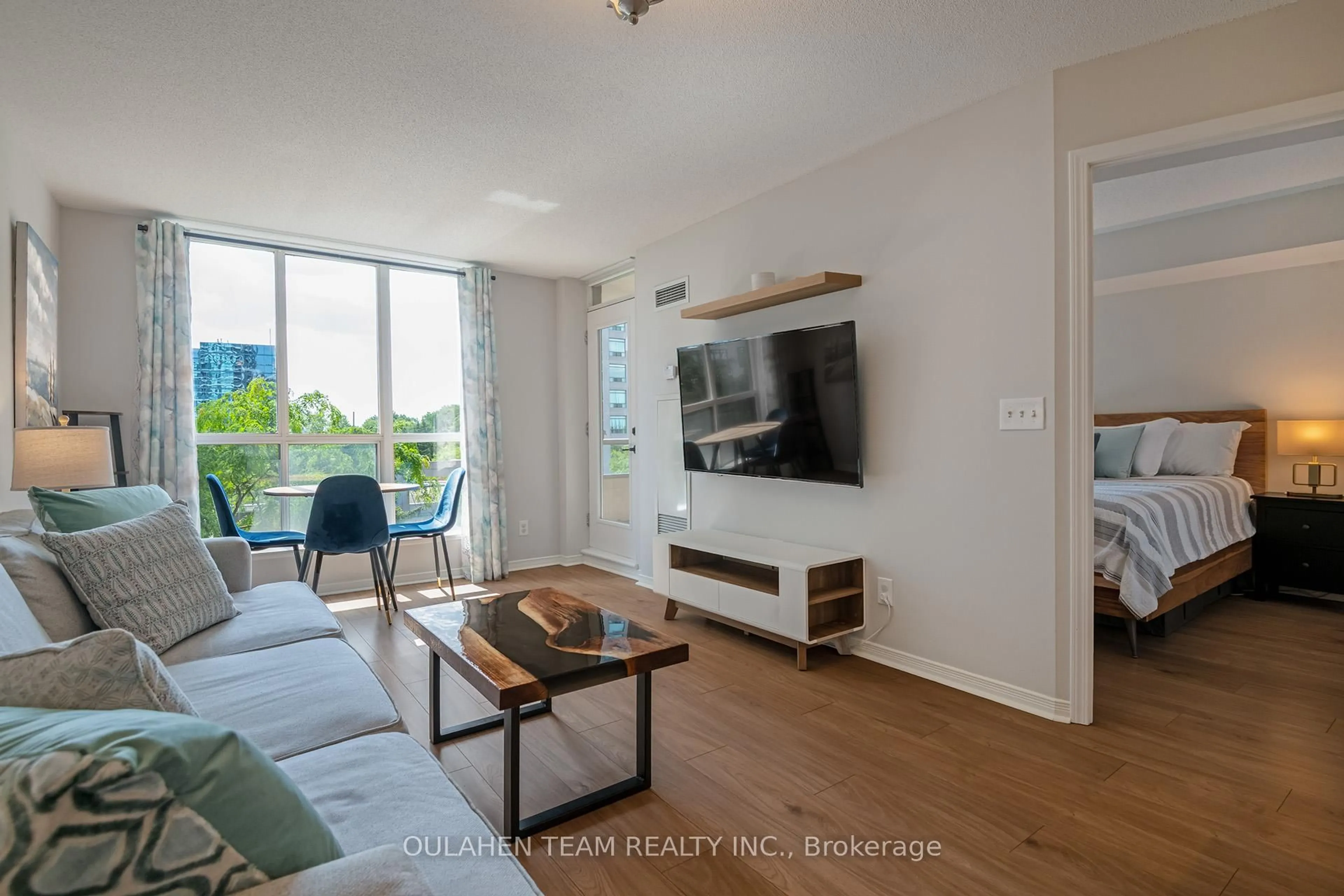 Living room with furniture, wood/laminate floor for 51 Harrison Garden Blvd #411, Toronto Ontario M2N 7G4