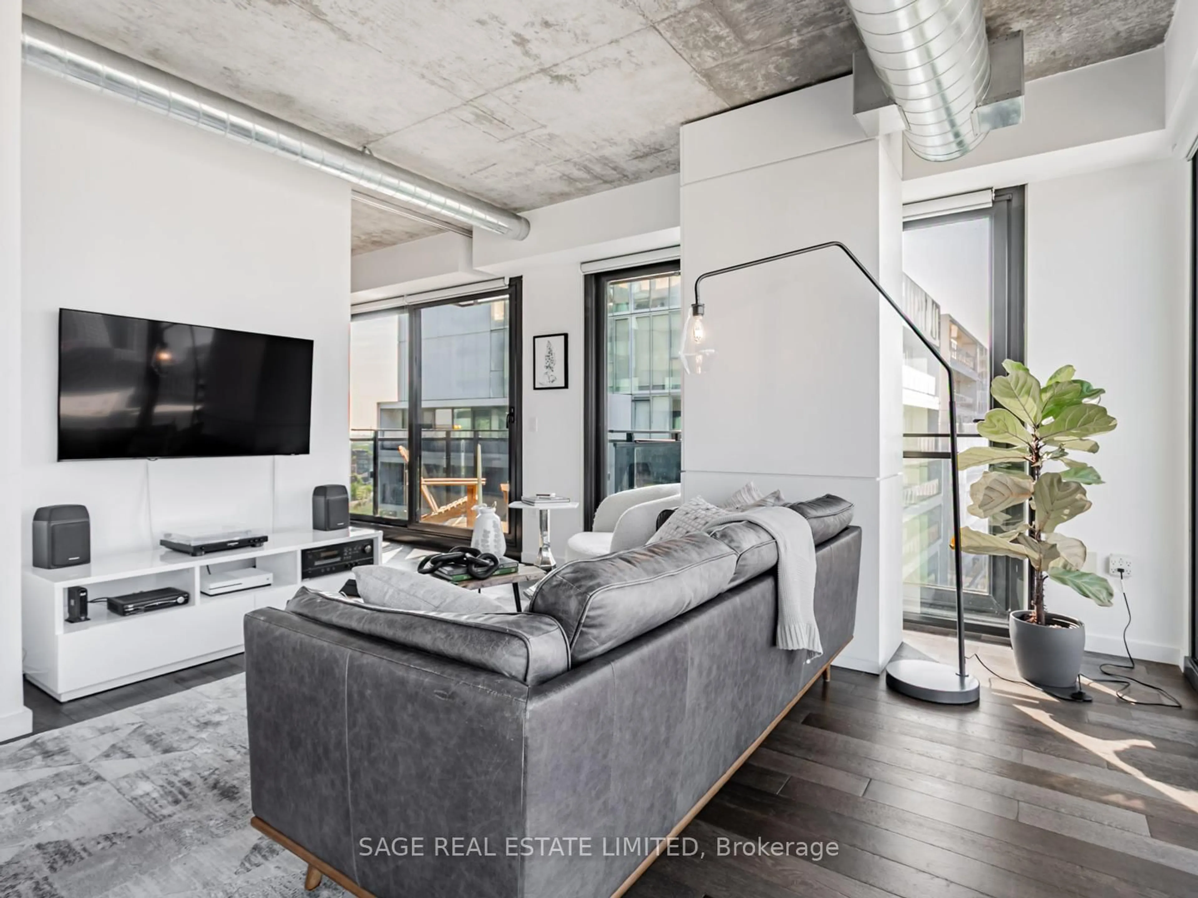 Living room with furniture, cement floor for 51 Trolley Cres #1209, Toronto Ontario M5A 0E9