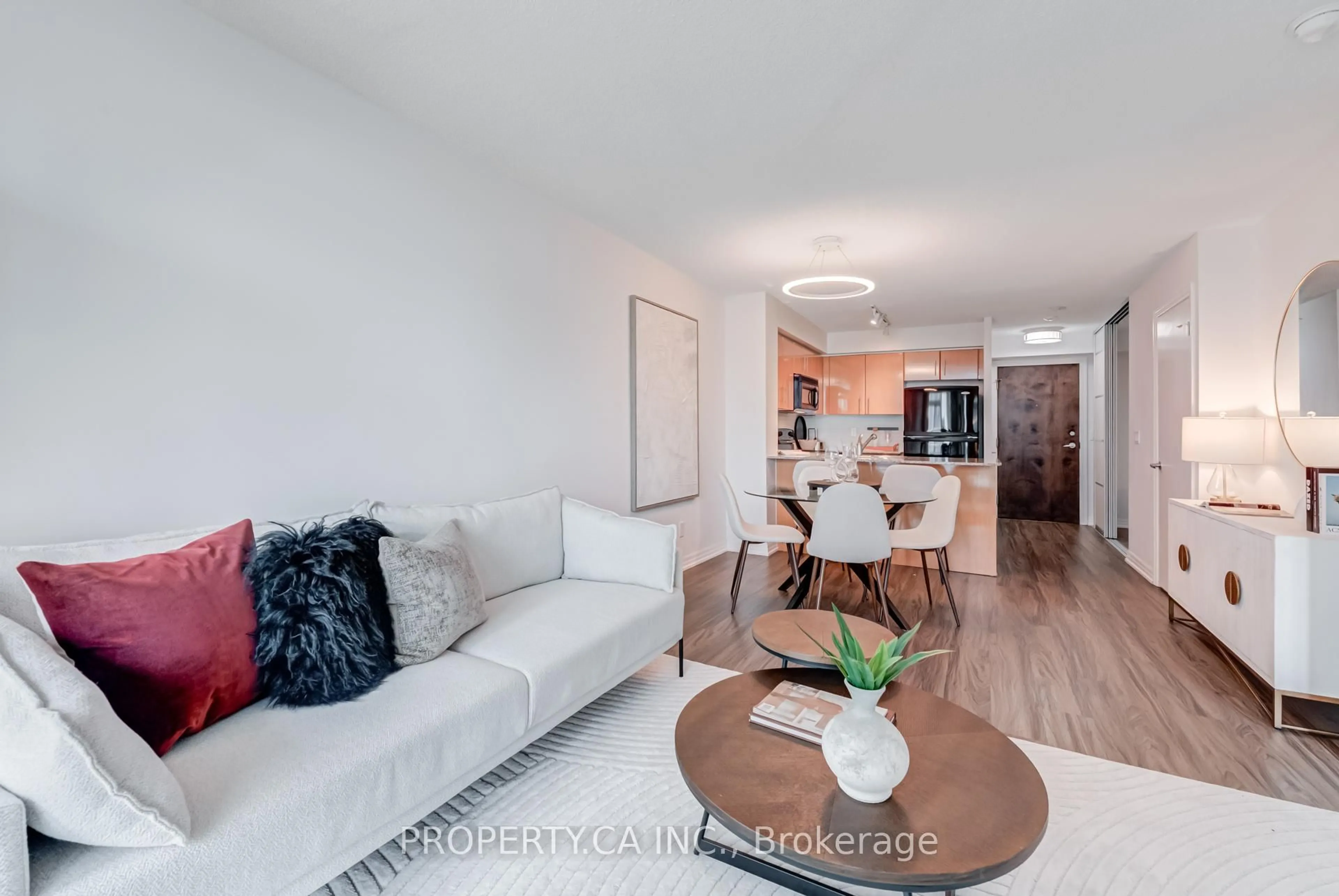 Living room with furniture, wood/laminate floor for 16 Yonge St #807, Toronto Ontario M5E 2A1