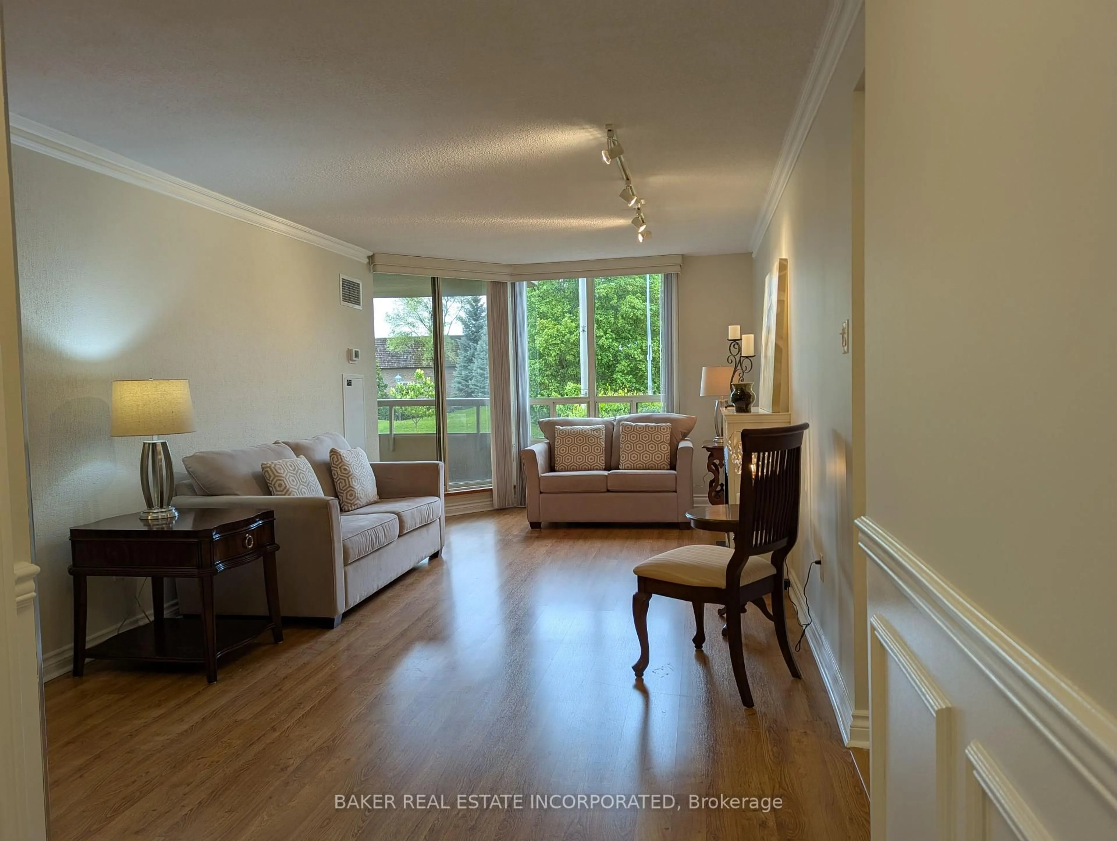 Living room with furniture, wood/laminate floor for 1200 Don Mills Rd #205, Toronto Ontario M3B 3N8