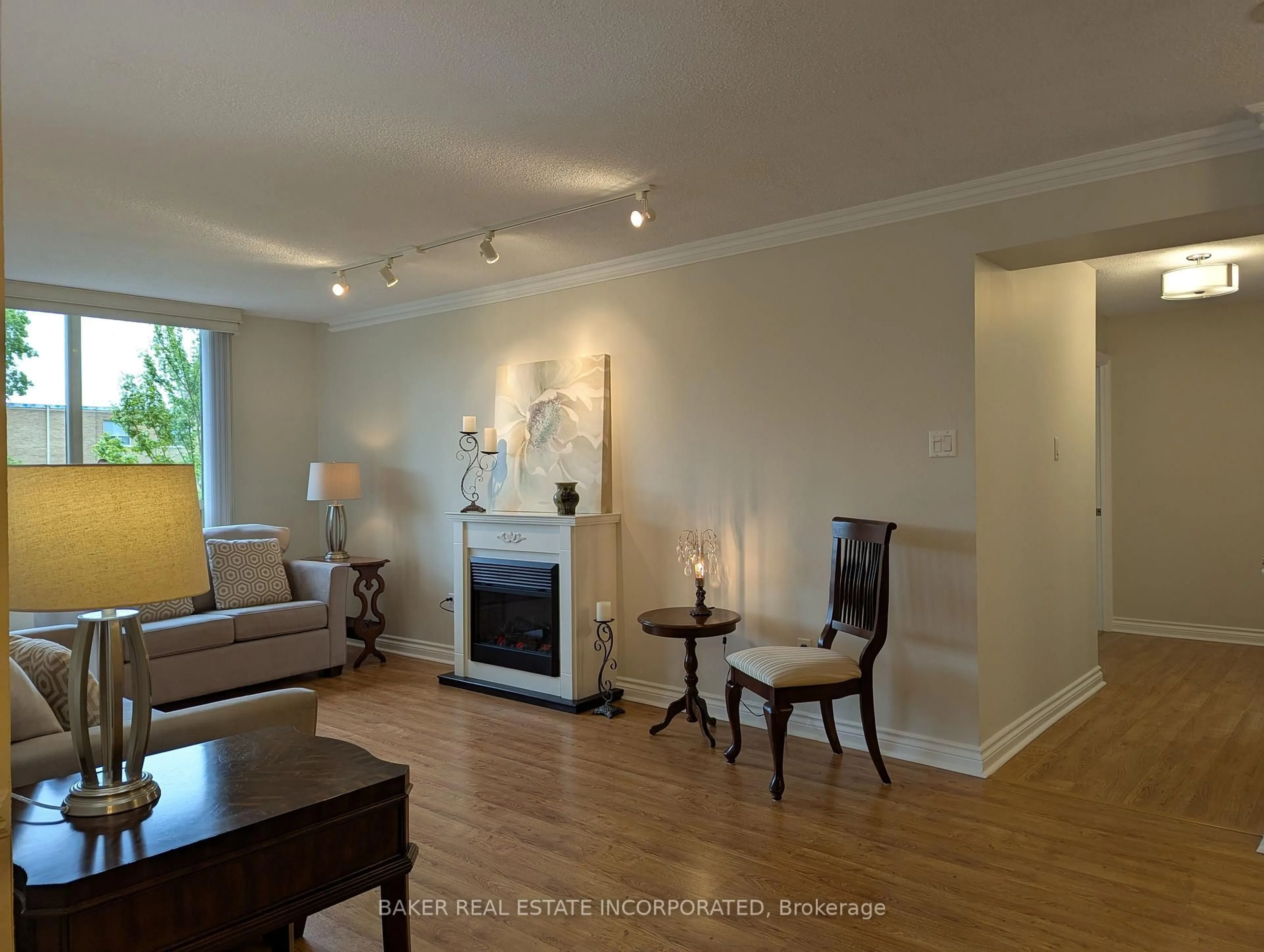Living room with furniture, wood/laminate floor for 1200 Don Mills Rd #205, Toronto Ontario M3B 3N8