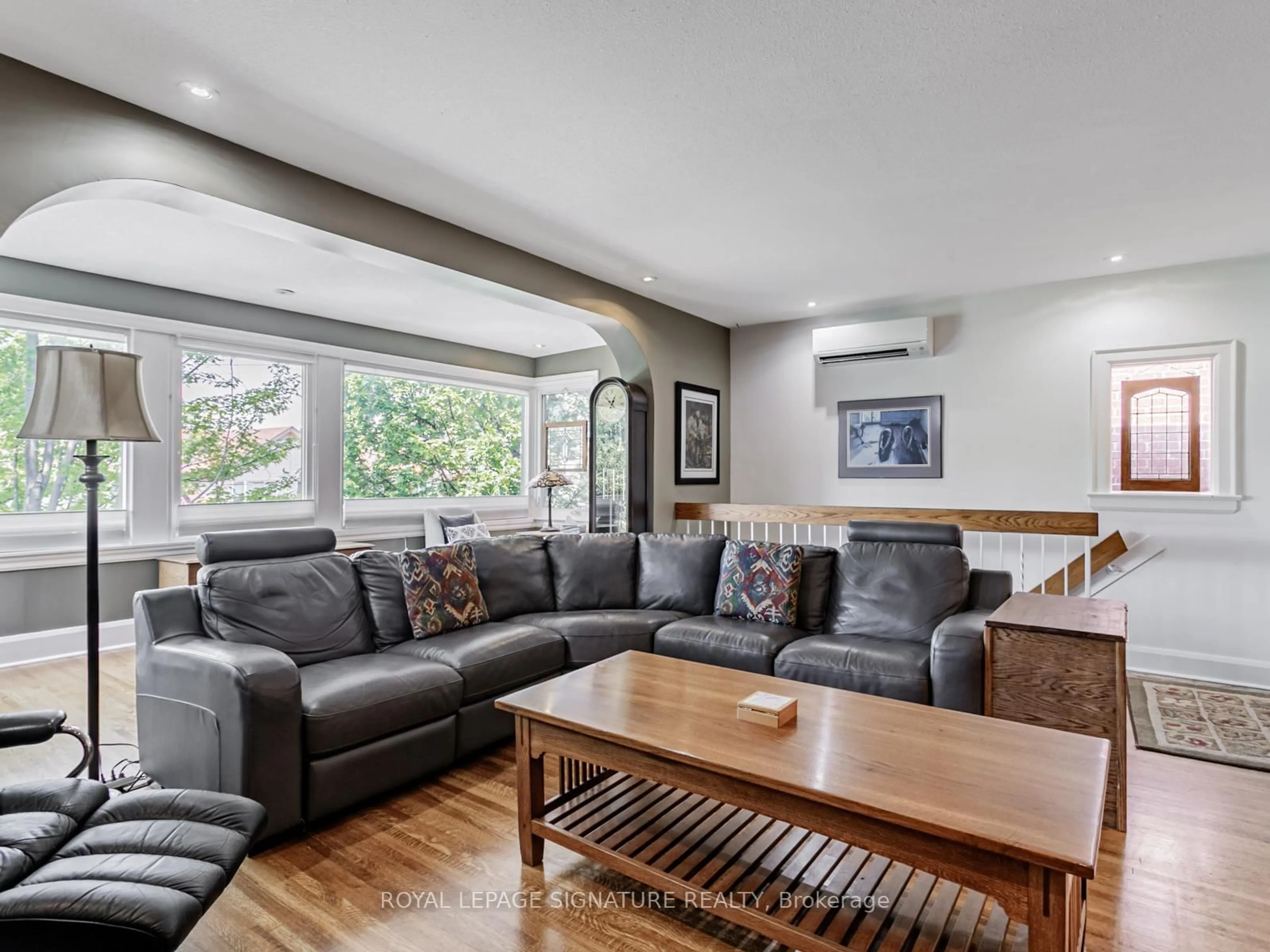 Living room with furniture, wood/laminate floor for 209 Arlington Ave, Toronto Ontario M6C 2Z4