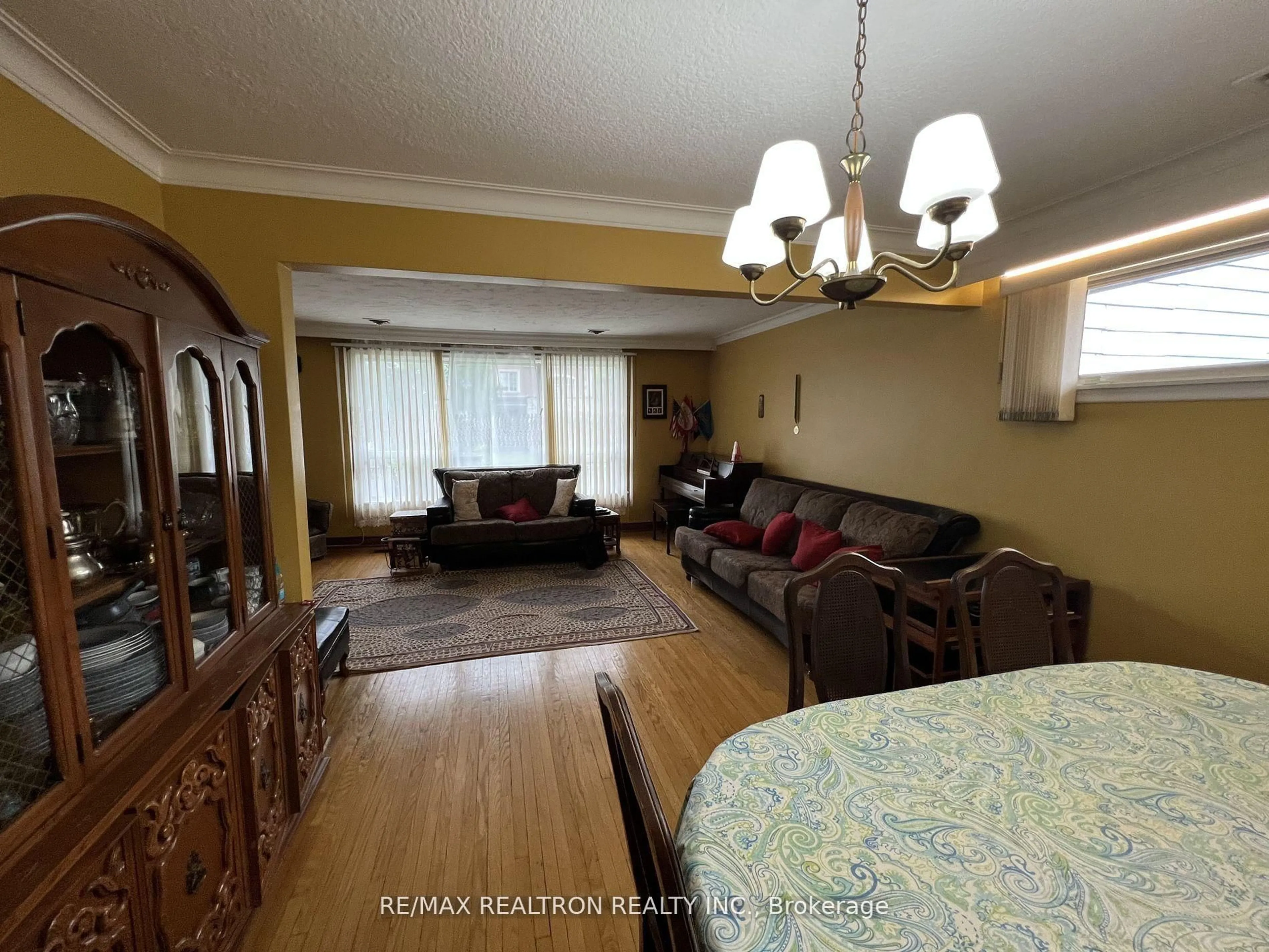 Living room with furniture, wood/laminate floor for 119 Regina Ave, Toronto Ontario M6A 1R8