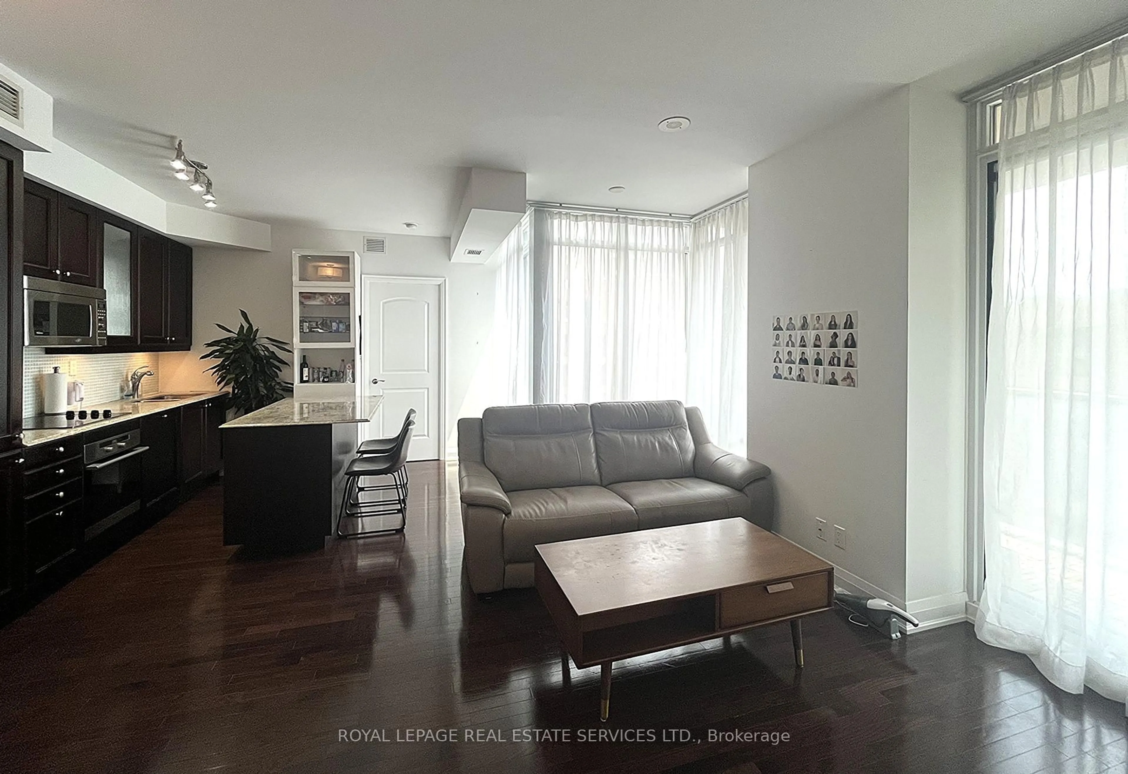 Living room with furniture, wood/laminate floor for 1 Bedford Rd #715, Toronto Ontario M5R 2B5