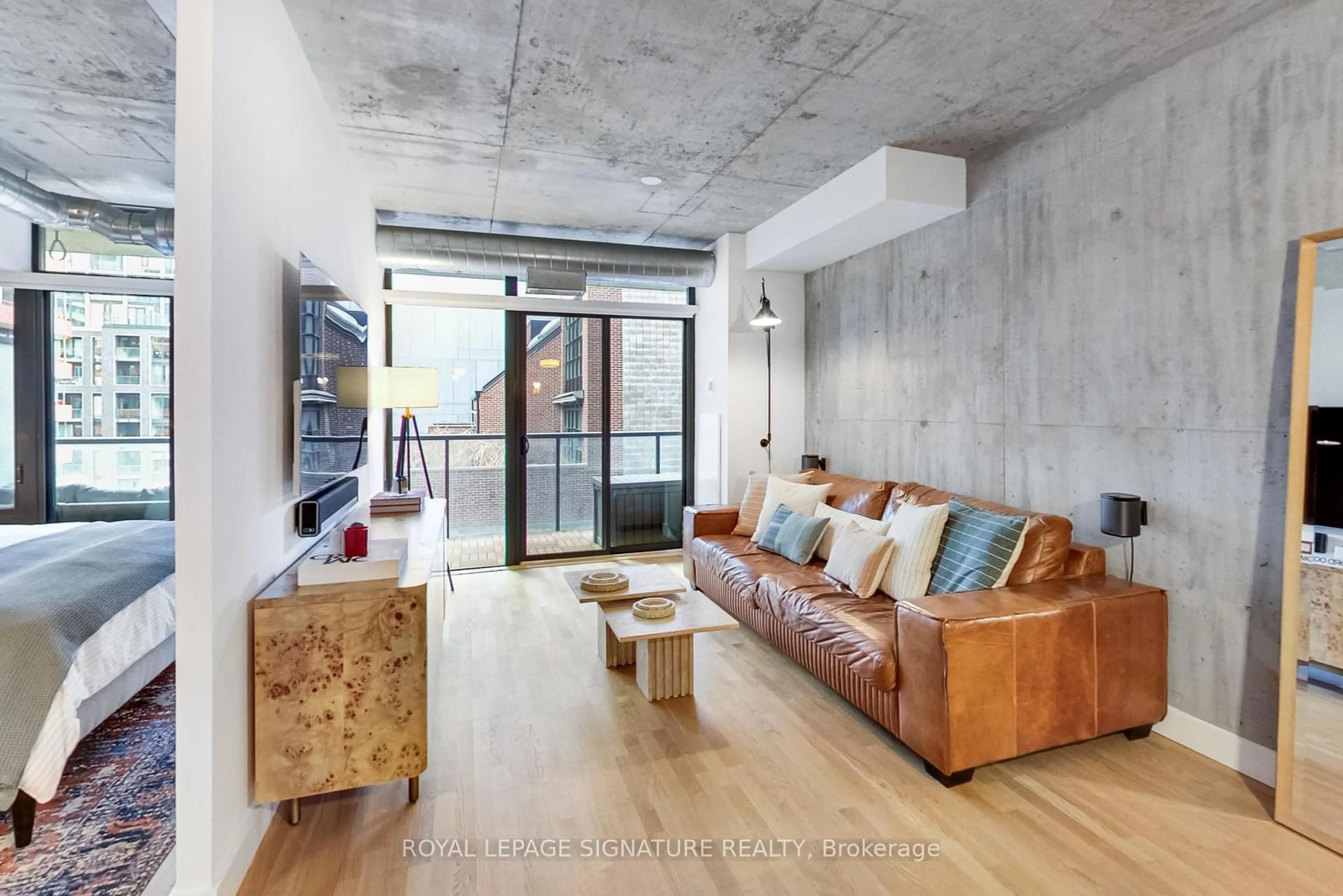 Living room with furniture, cement floor for 138 Princess St #614, Toronto Ontario M5A 0B1