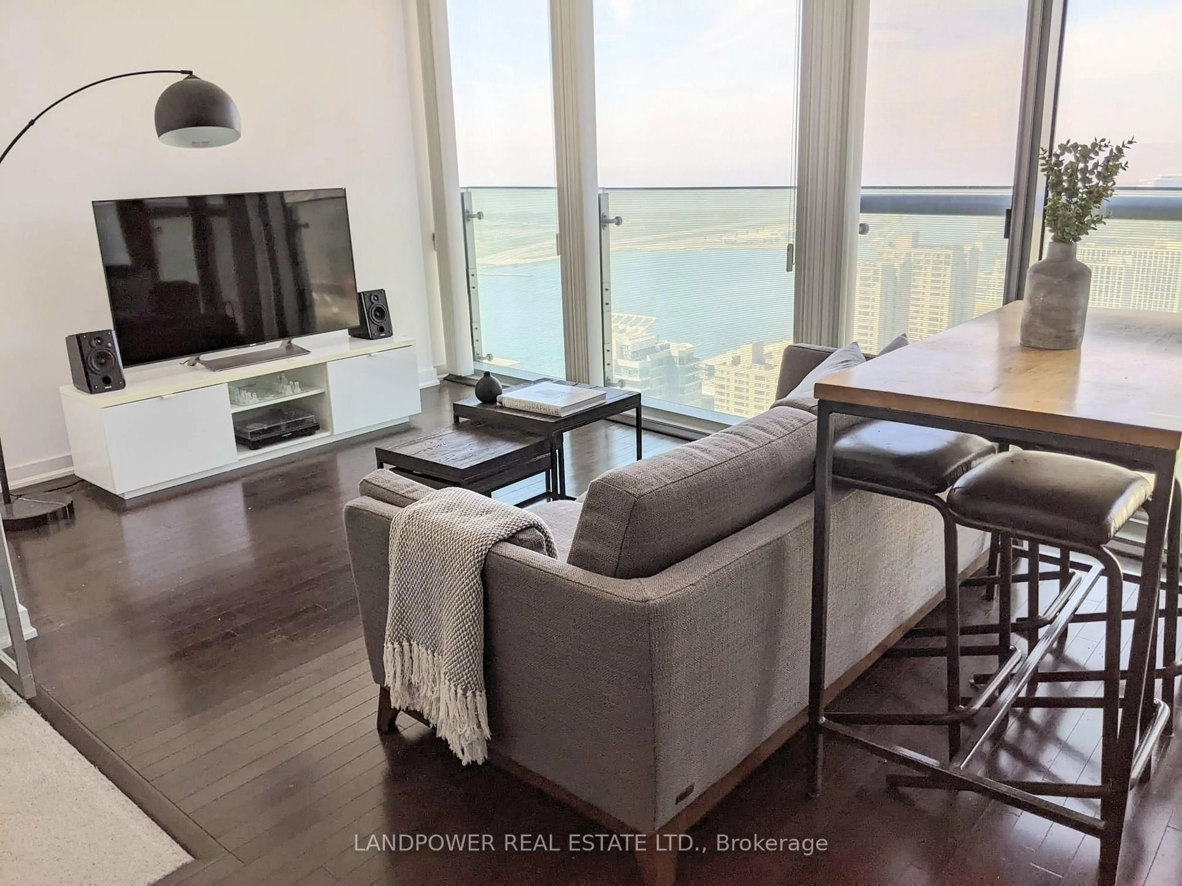 Living room with furniture, wood/laminate floor for 12 York St #3906, Toronto Ontario M5J 0A9