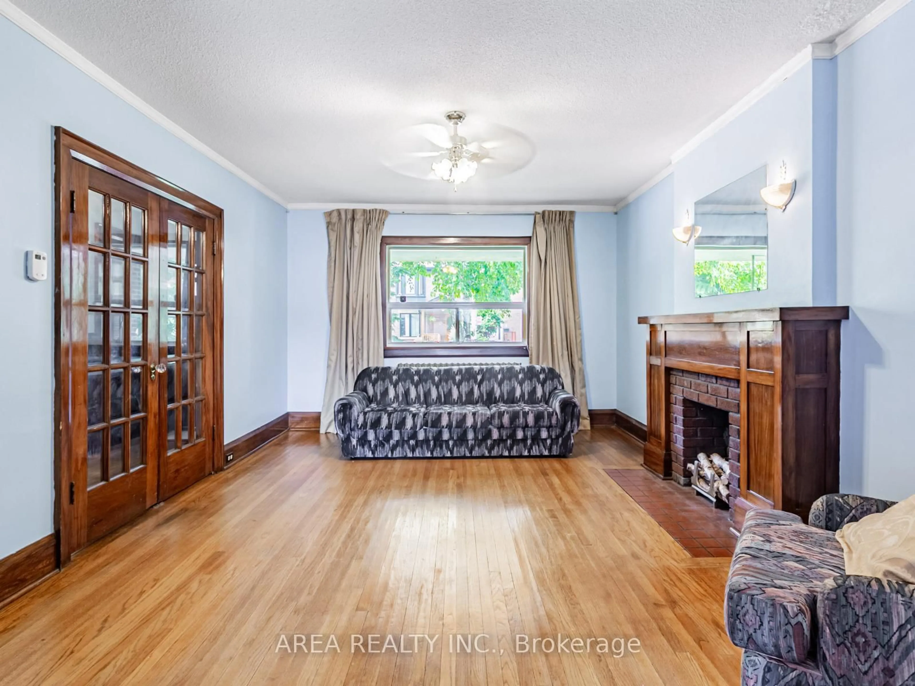 Living room with furniture, wood/laminate floor for 65 St Annes Rd, Toronto Ontario M6J 2C4